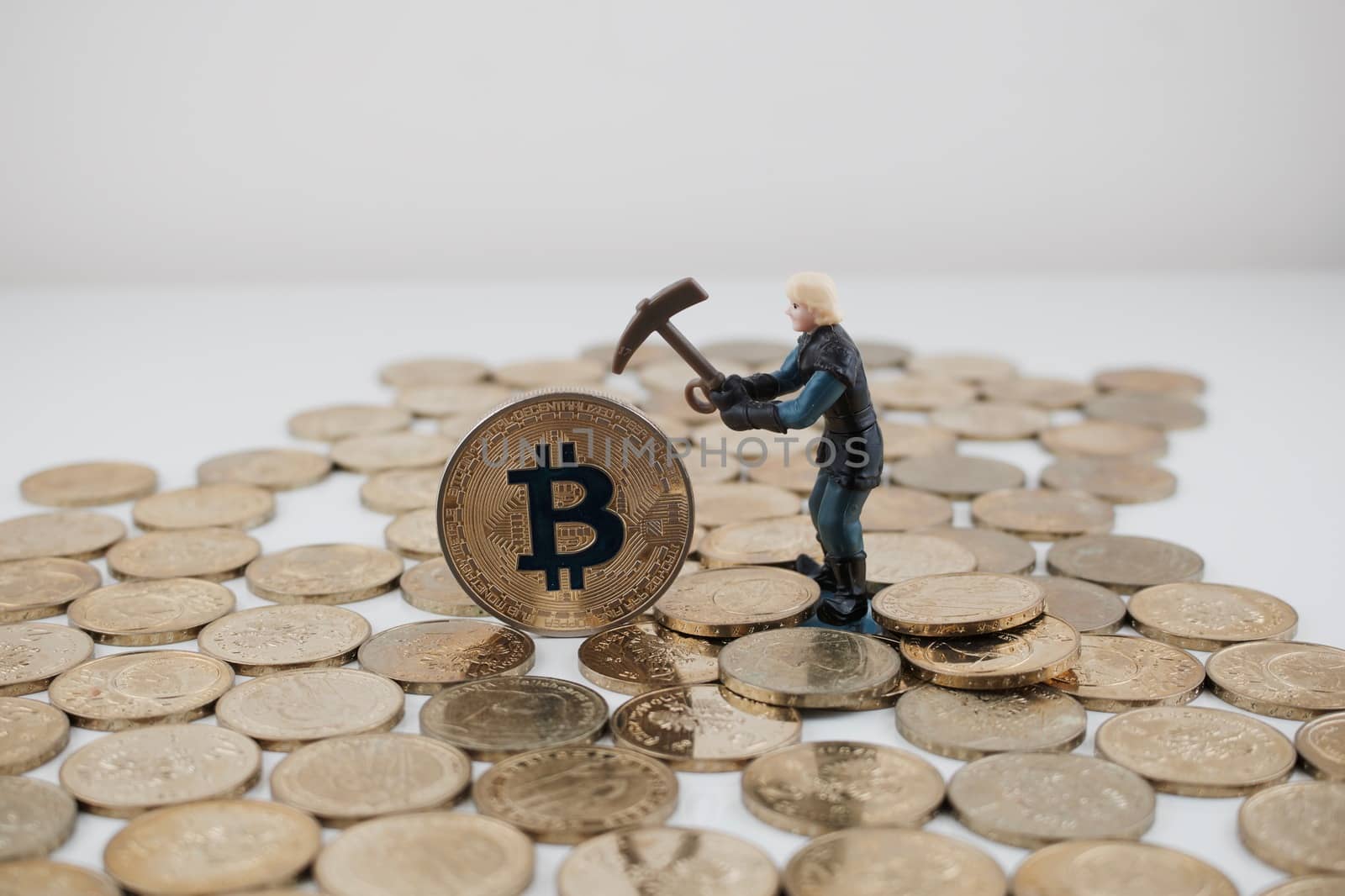 Cryptocurrency physical gold bitcoin coin and picking miner