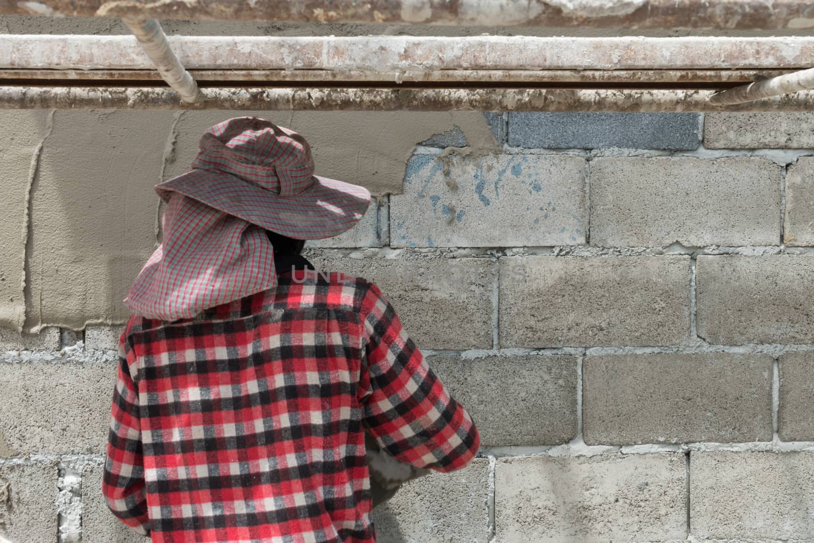 Close up of industrial bricklayer installing cement on construction site