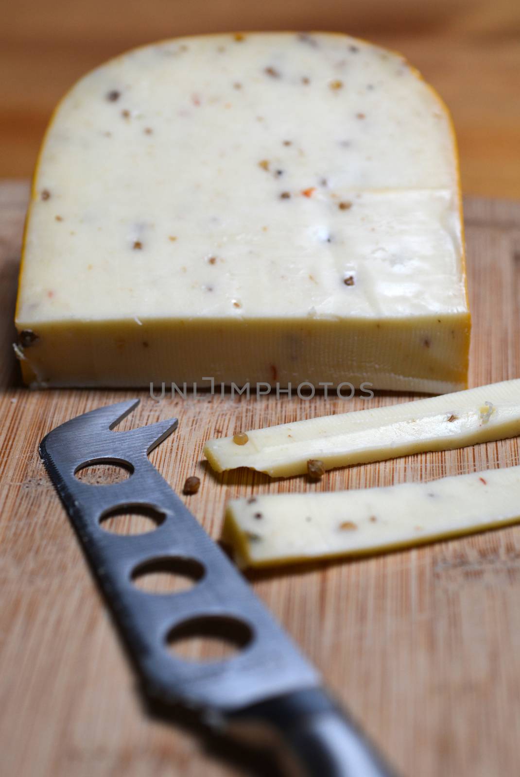 Cheese and knife on a bamboo board