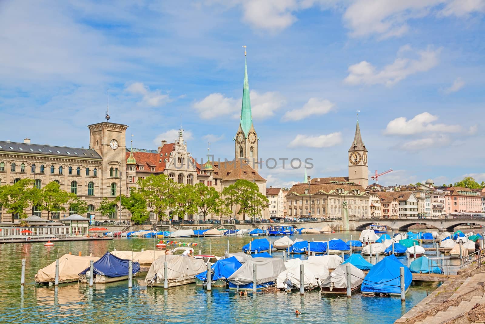 Panorama of historical part of Zurich with famous Fraumunster and St. Peter church on a beautiful summer day, Switzerland.