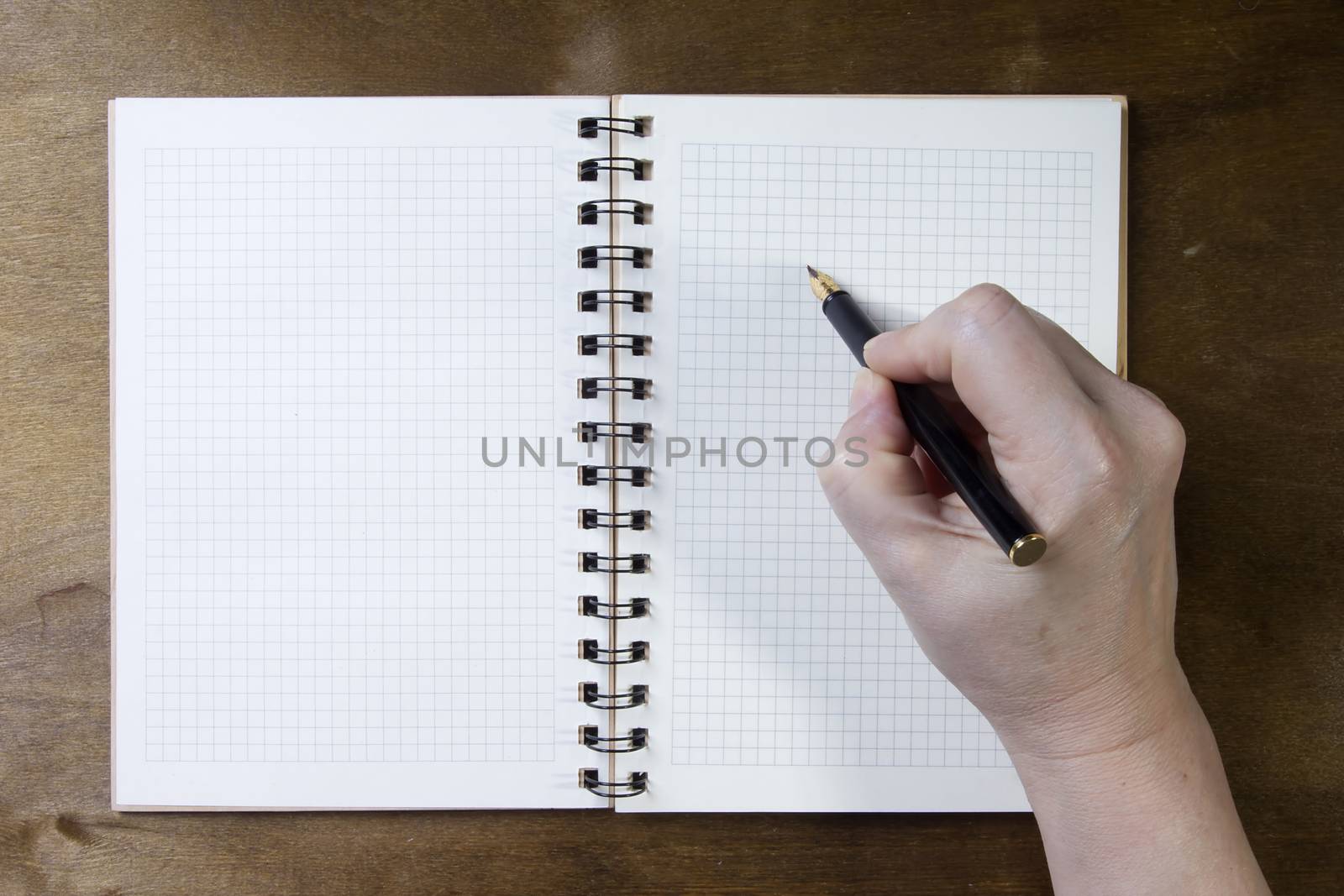 Hand writing on empty notepad by VIPDesignUSA