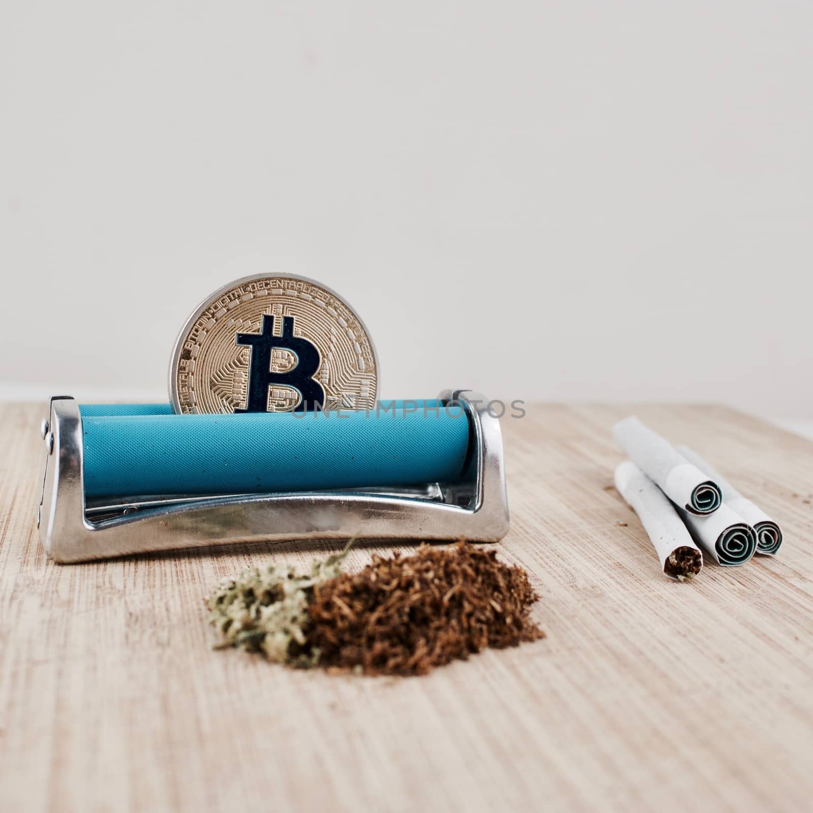 Digital currency physical gold bitcoin coin. Addict marijuana and joints concept.