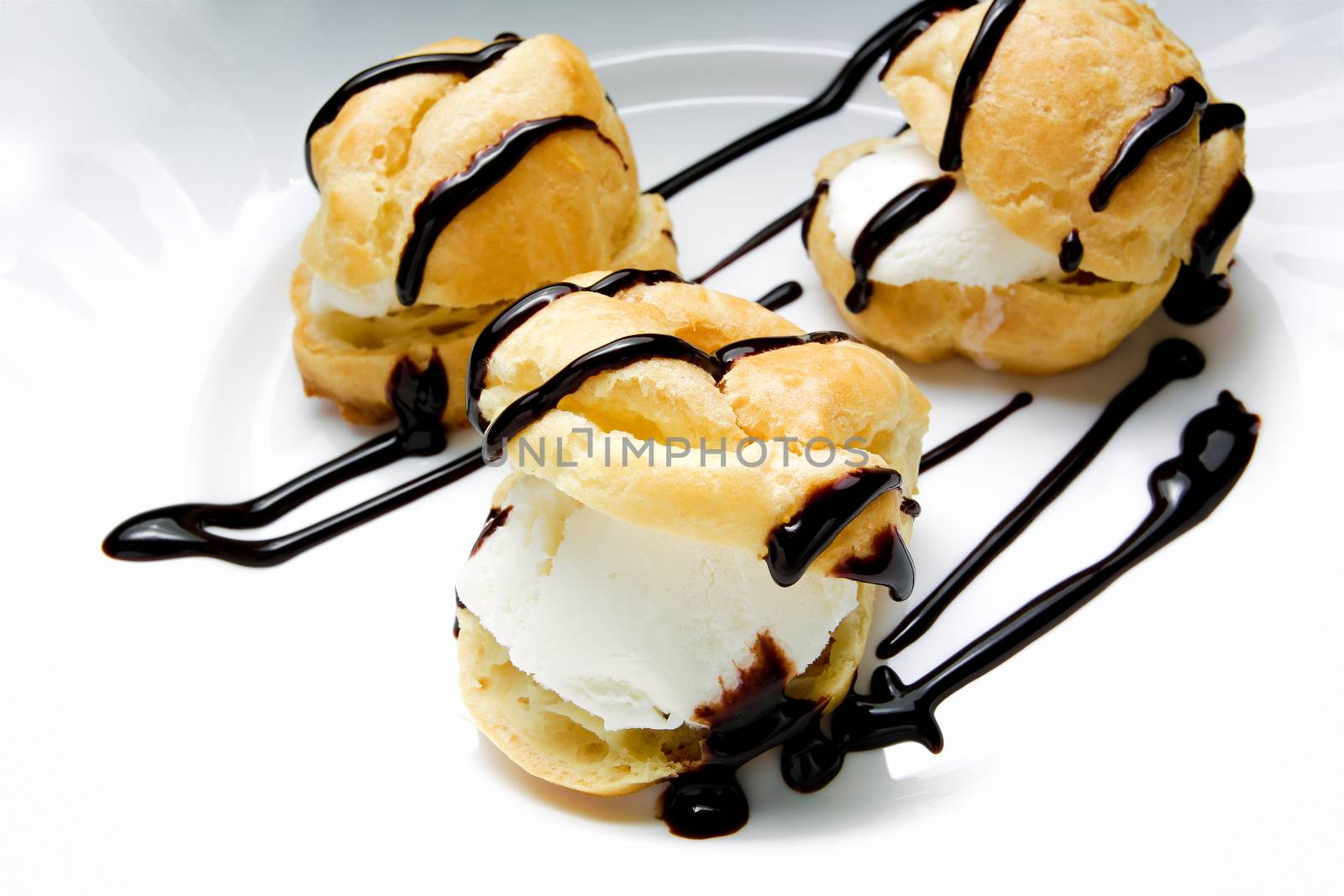 Profiteroles with ice cream. On a white background