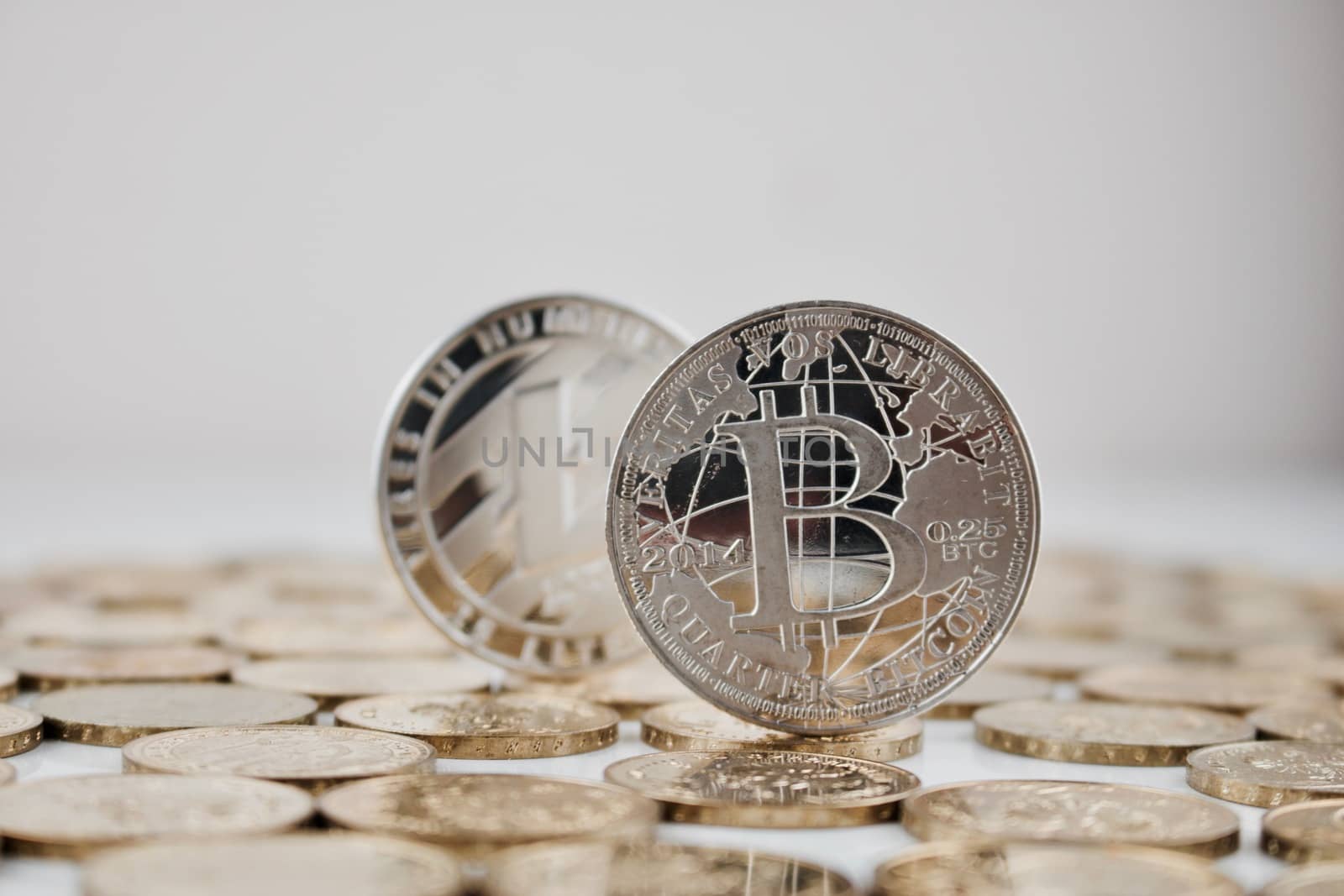 Digital currency physical silver bitcoin coin and silver Litecoin coin.