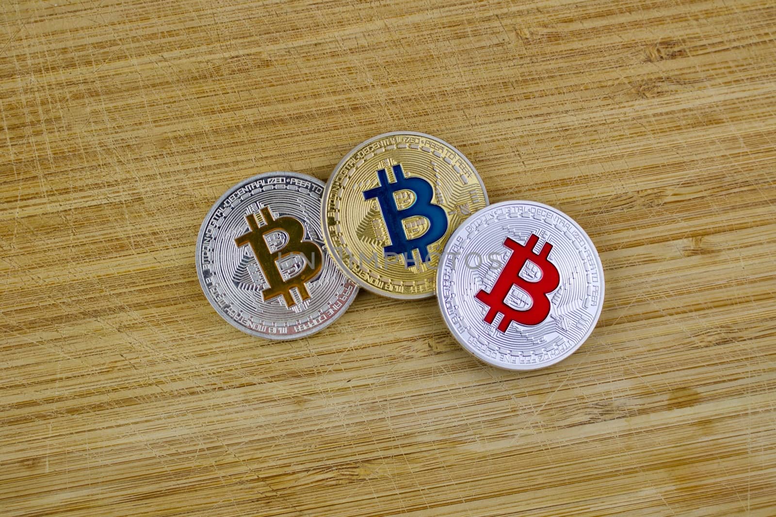 Digital currency physical silver and gold bitcoin coins on the wooden board.