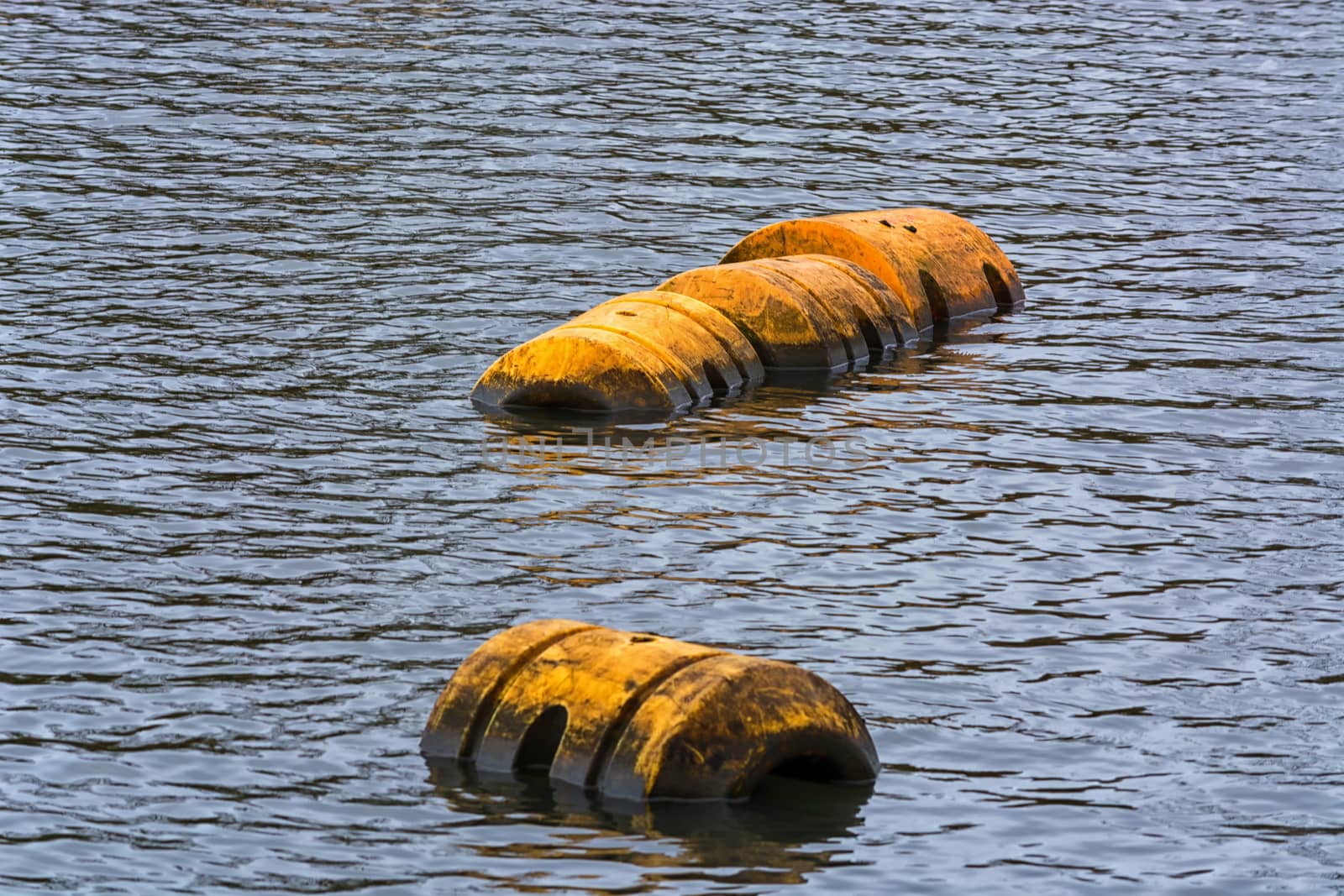 Buoy, pipeline or plastic floats float on the water surface.