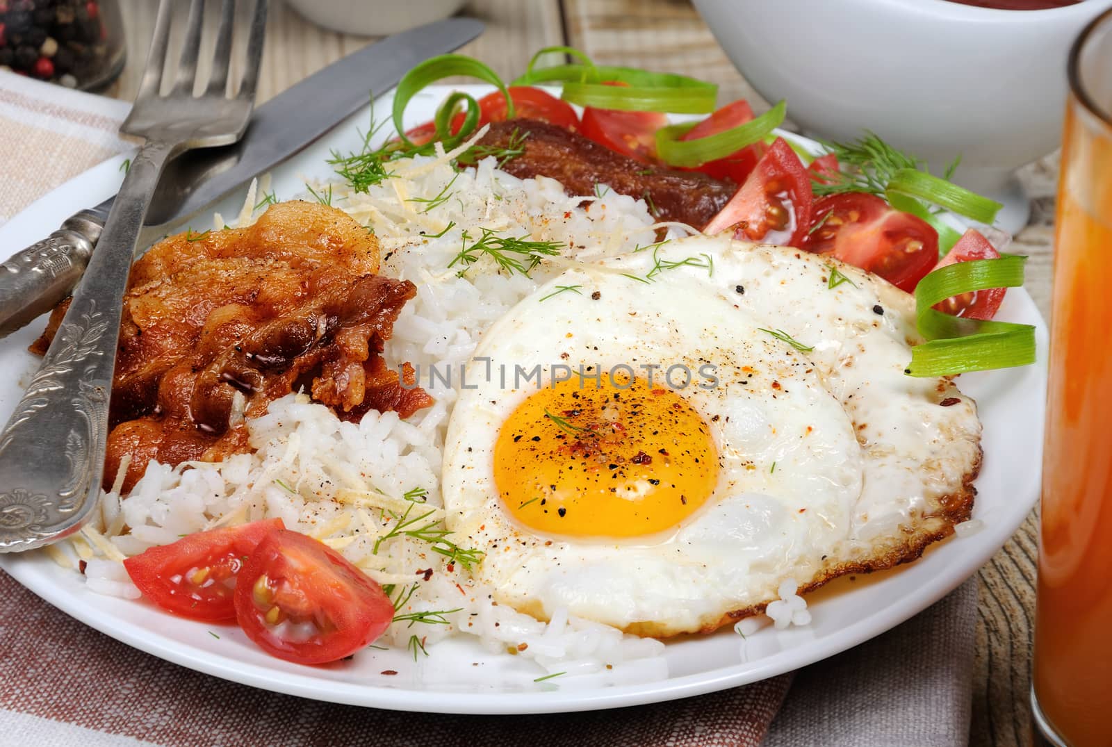 Breakfast - Soft boiled rice with scrambled eggs, bacon, tomato slices and greens