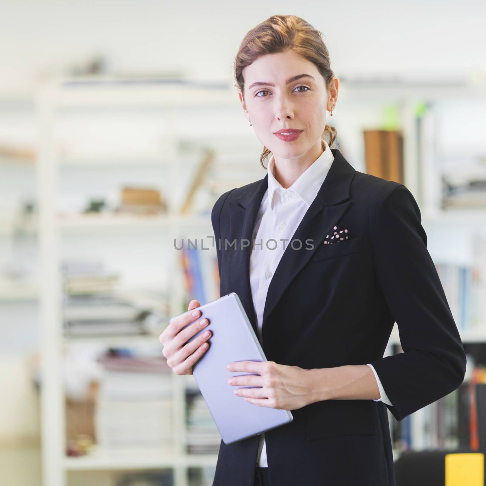 Portrait of businesswoman with digital tablet in office