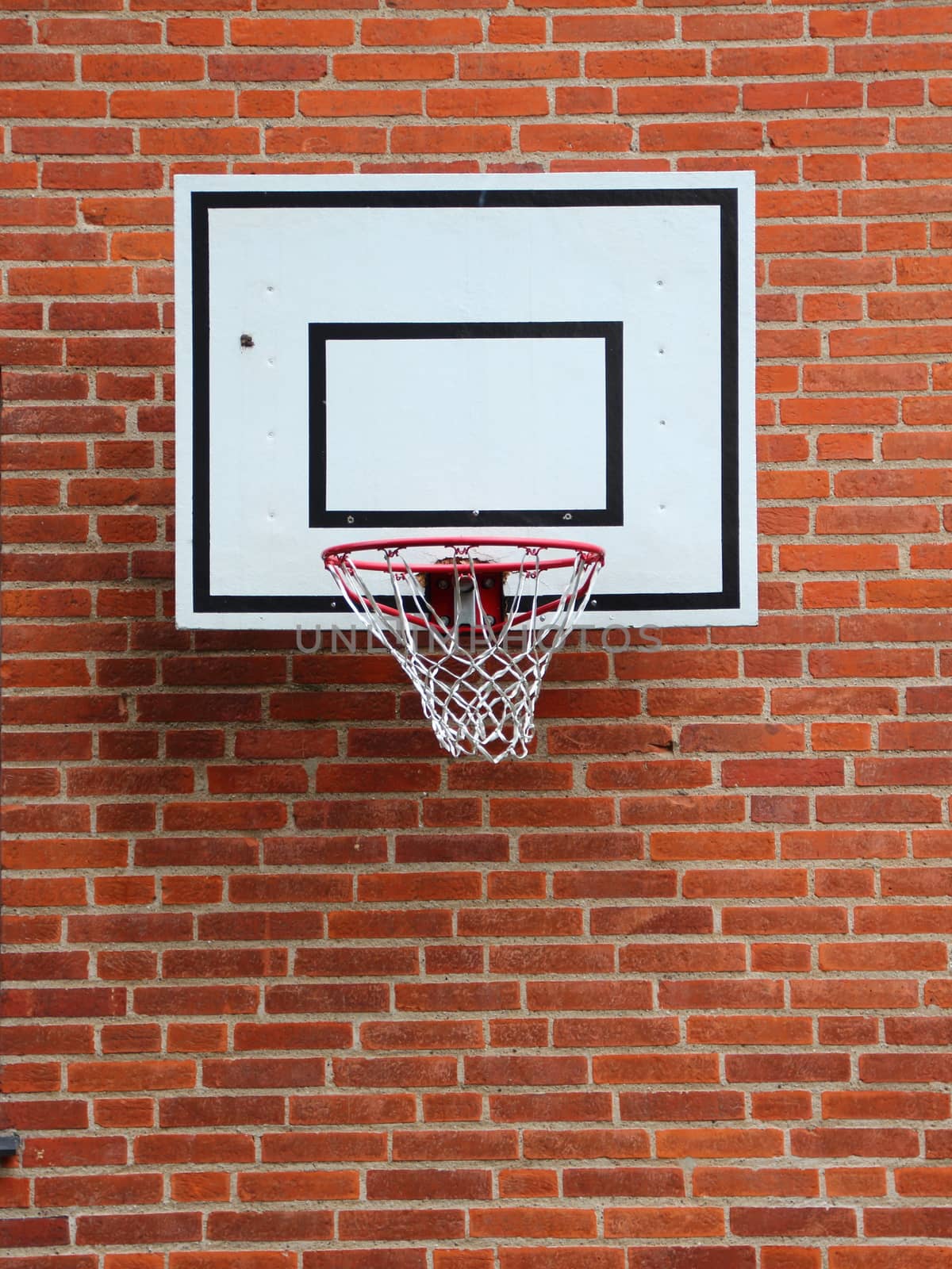 White Basketball Net Mounted on Red Brickwall by HoleInTheBox