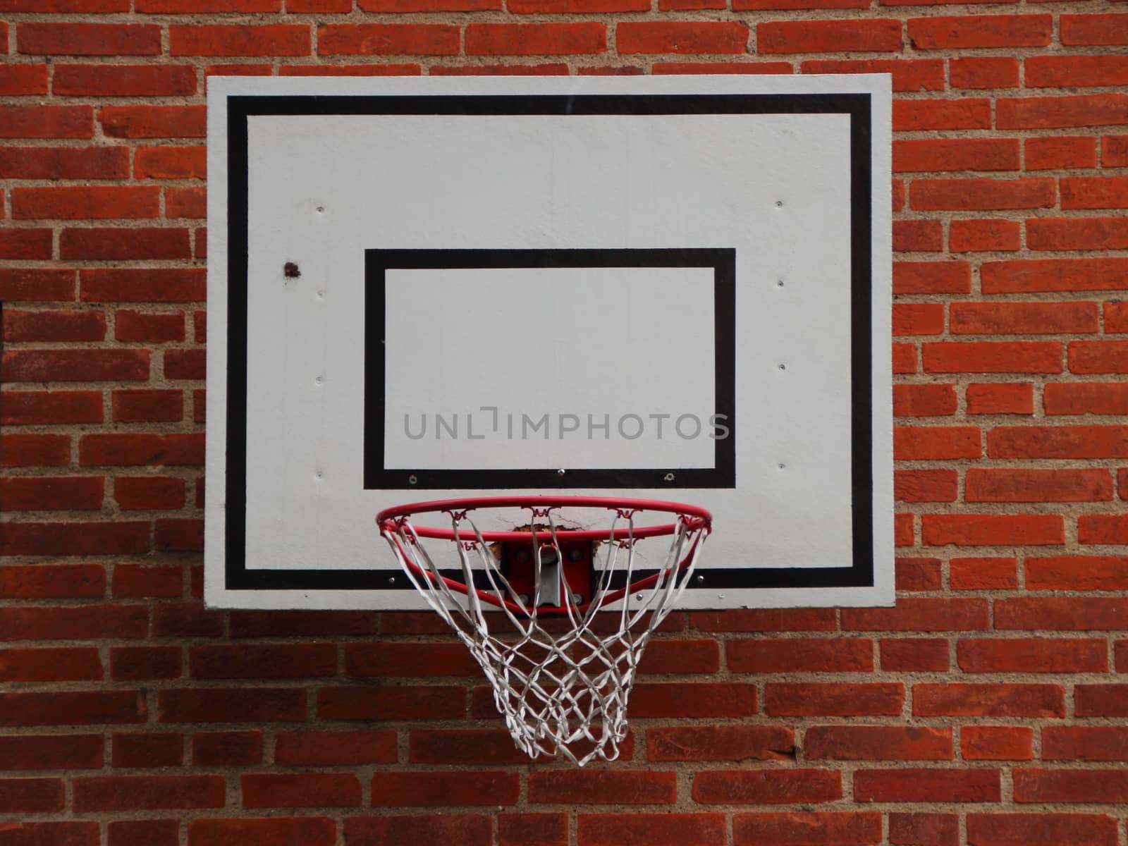 White Basketball Net Mounted on Red Brickwall background