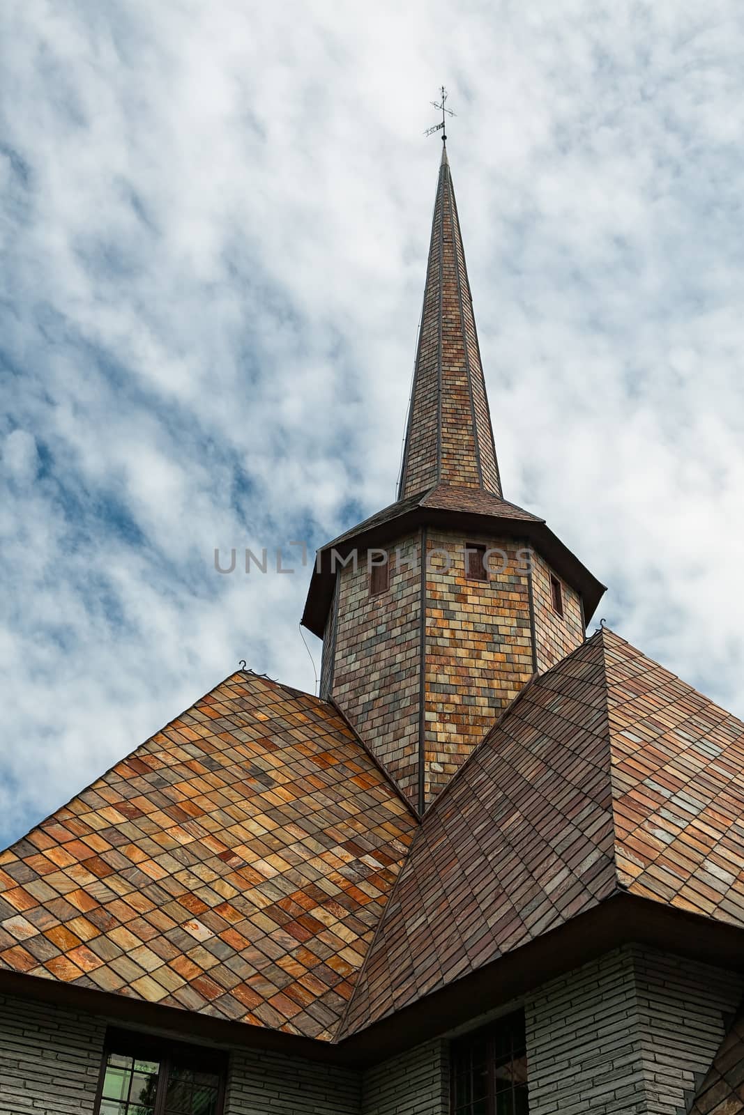 Closeup of the rooftop of the little church in Dombas village in Norway under a cloudy sky
