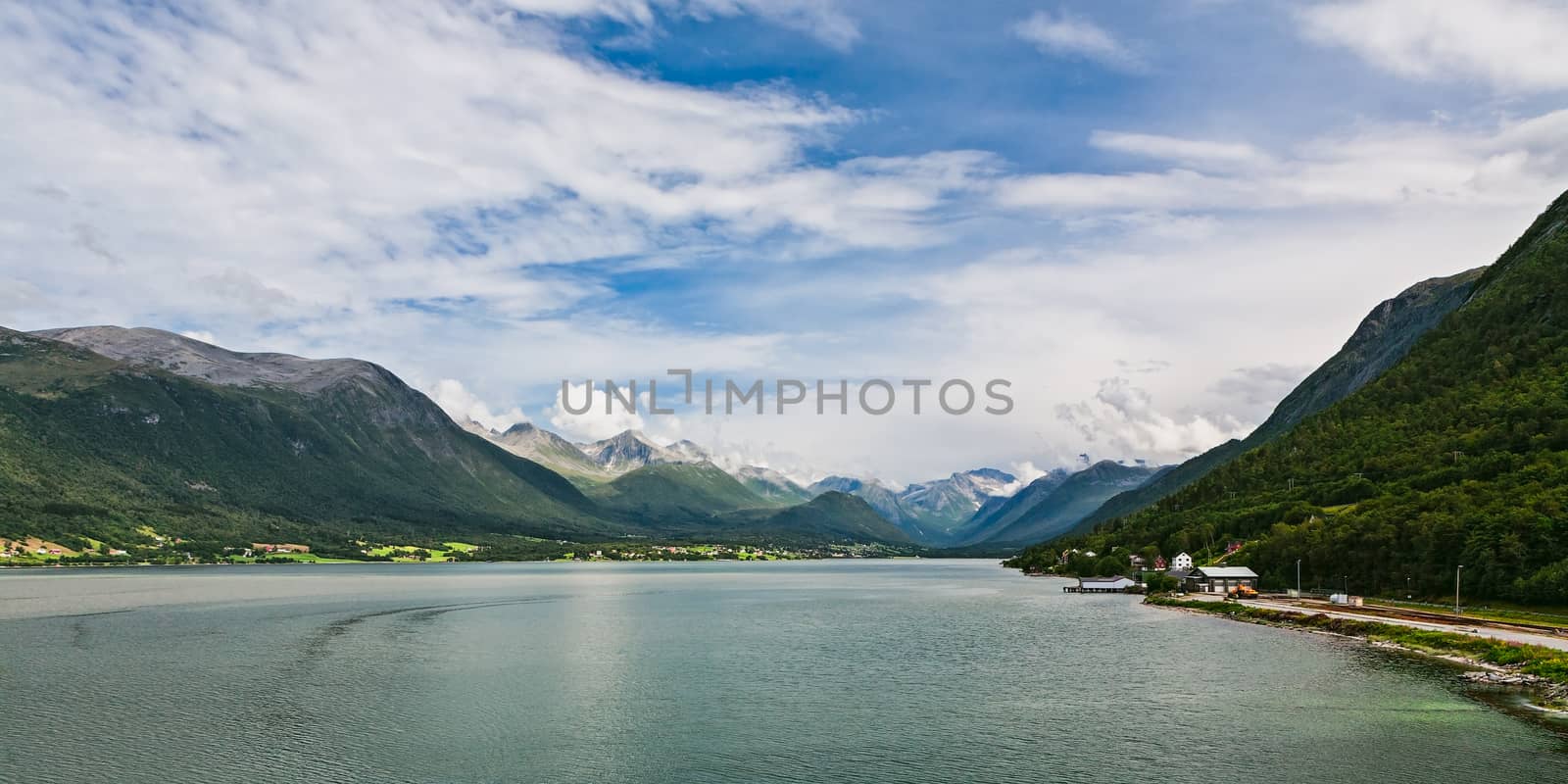 Panoramic view of Romsdalsfjorden and mountains from Andalsnes in Norway under a sunny sky