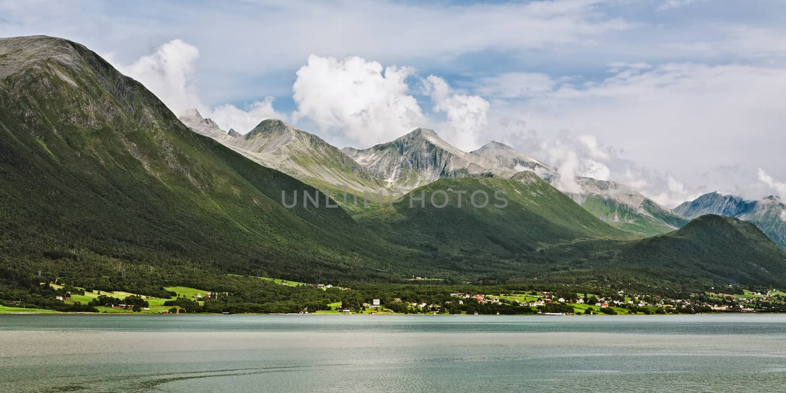 Panoramic view of the mountains along the Romsdalsfjorden in Norway under a sunny sky