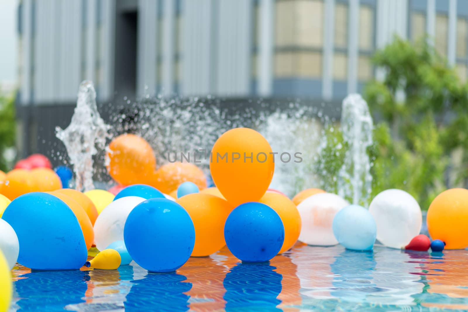 color balloons floating in a pool