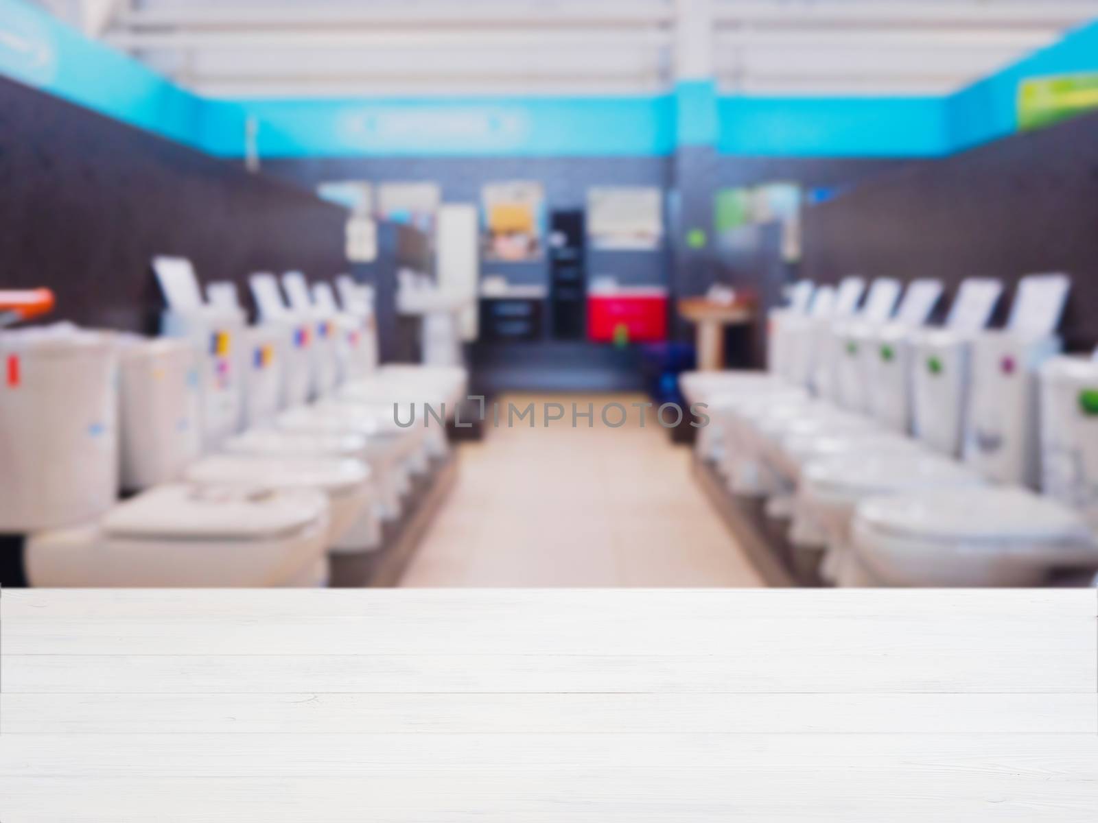 White wooden empty table in front of blurred DIY supermarket background. Mock up for display of product.