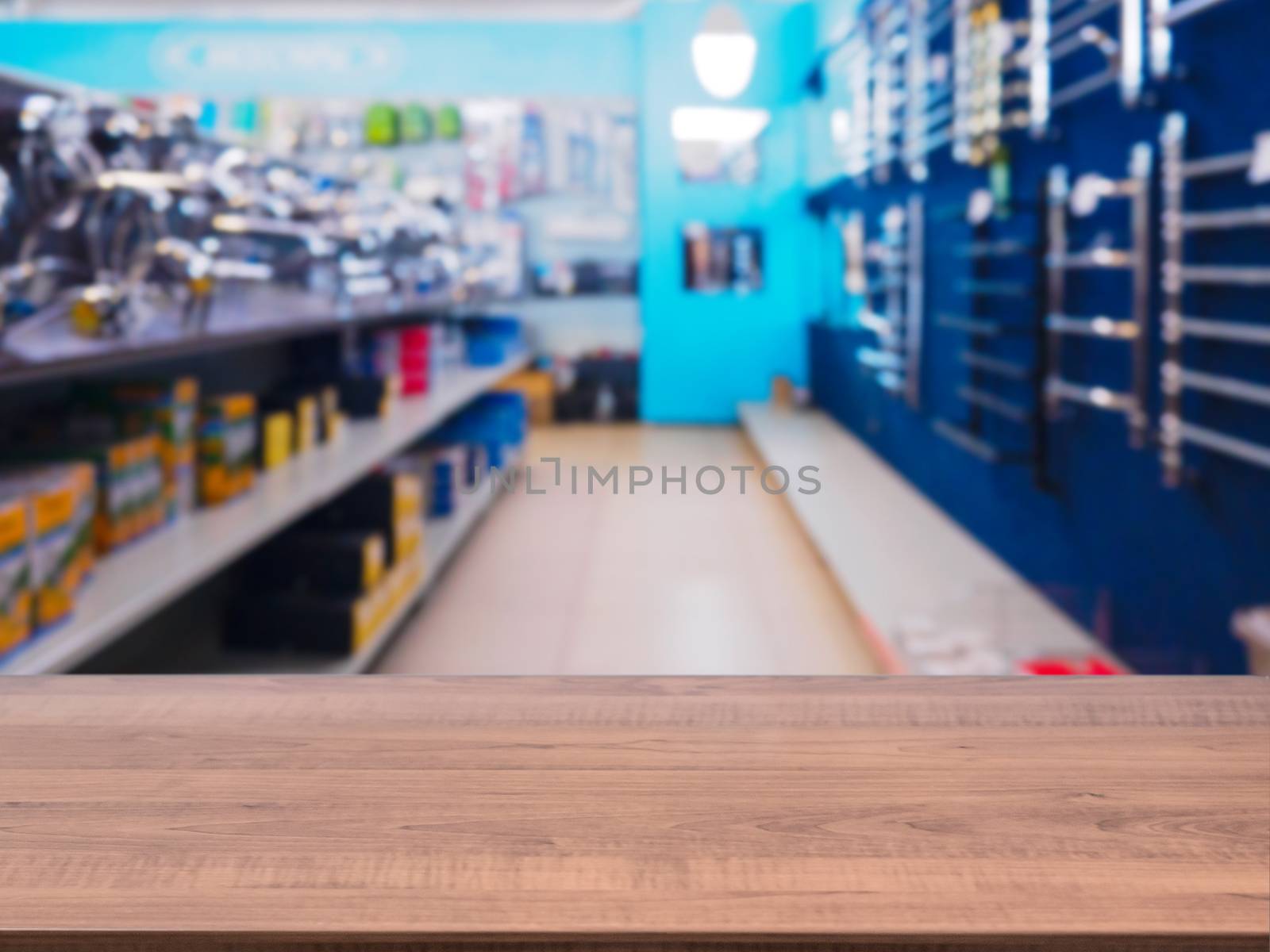 Brown wooden empty table in front of blurred DIY supermarket background. Mock up for display of product.