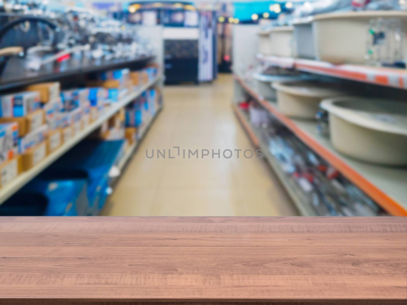 Brown wooden empty table in front of blurred DIY supermarket background. Mock up for display of product.