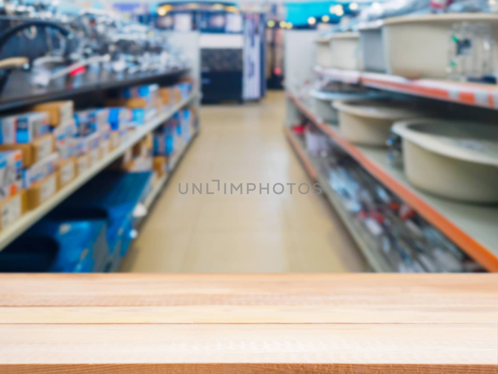 Light wooden empty table in front of blurred DIY supermarket background. Mock up for display of product.