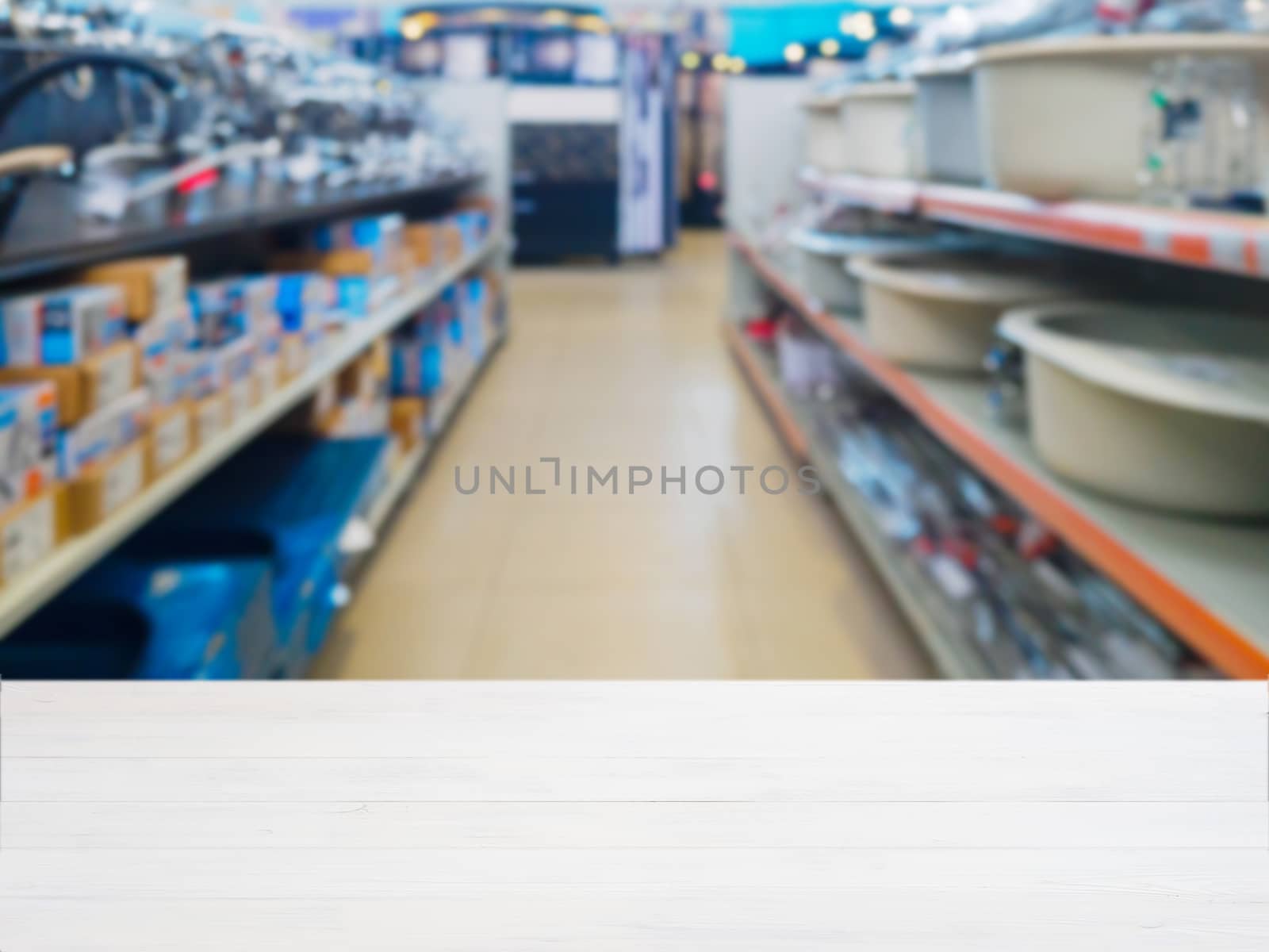 White wooden empty table in front of blurred DIY supermarket background. Mock up for display of product.