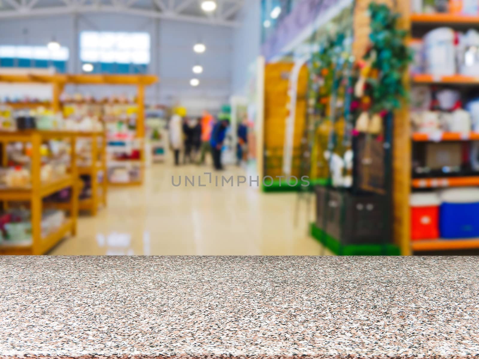 Marble empty table in front of blurred DIY supermarket background. Mock up for display of product.