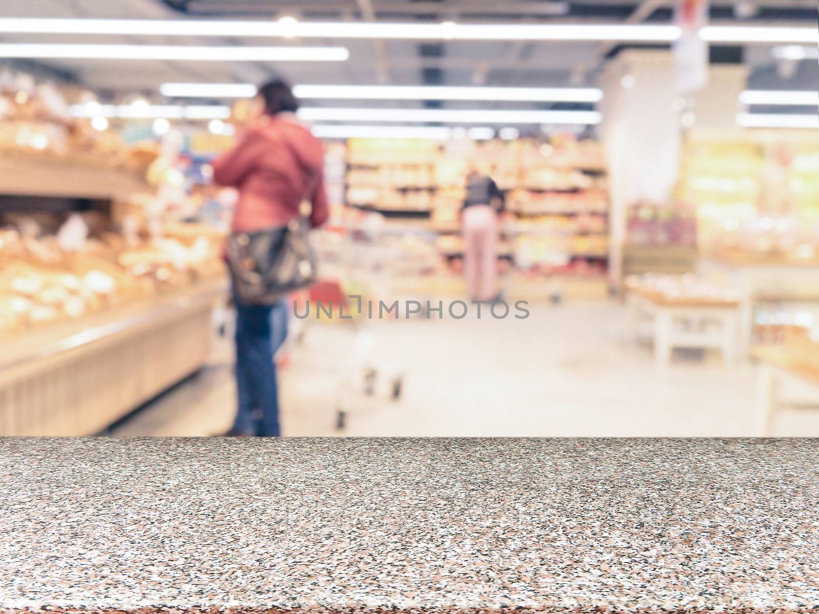 Marble board empty table in front of blurred supermarket - can be used for display or montage your products. Mockup for display of product.