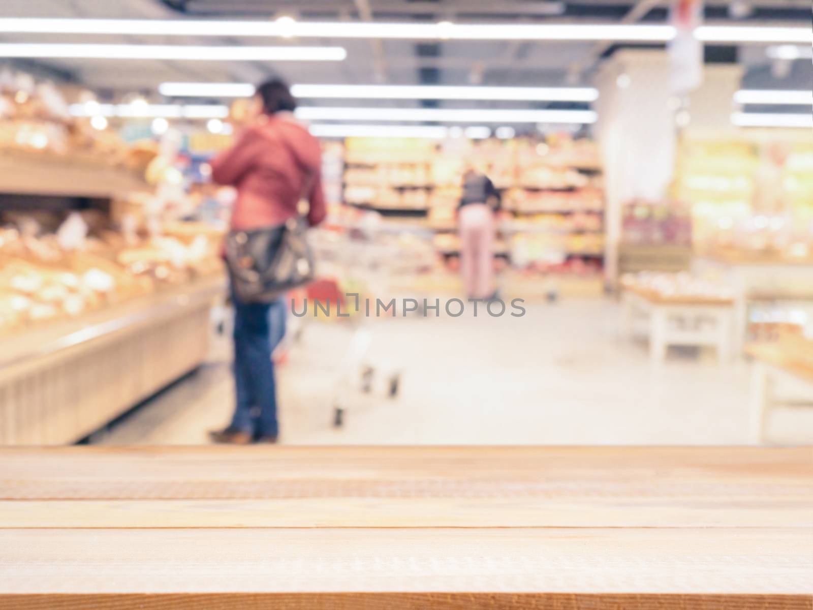 Light wooden board empty table in front of blurred background. Perspective light wood over blur in supermarket - can be used for display or montage your products. Mockup for display of product.