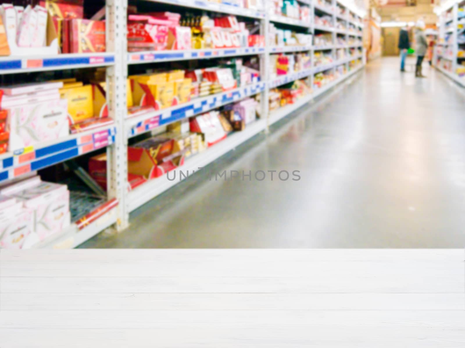 White wooden board empty table in front of blurred background. Perspective white wood over blur in supermarket - can be used for display or montage your products. Mockup for display of product.