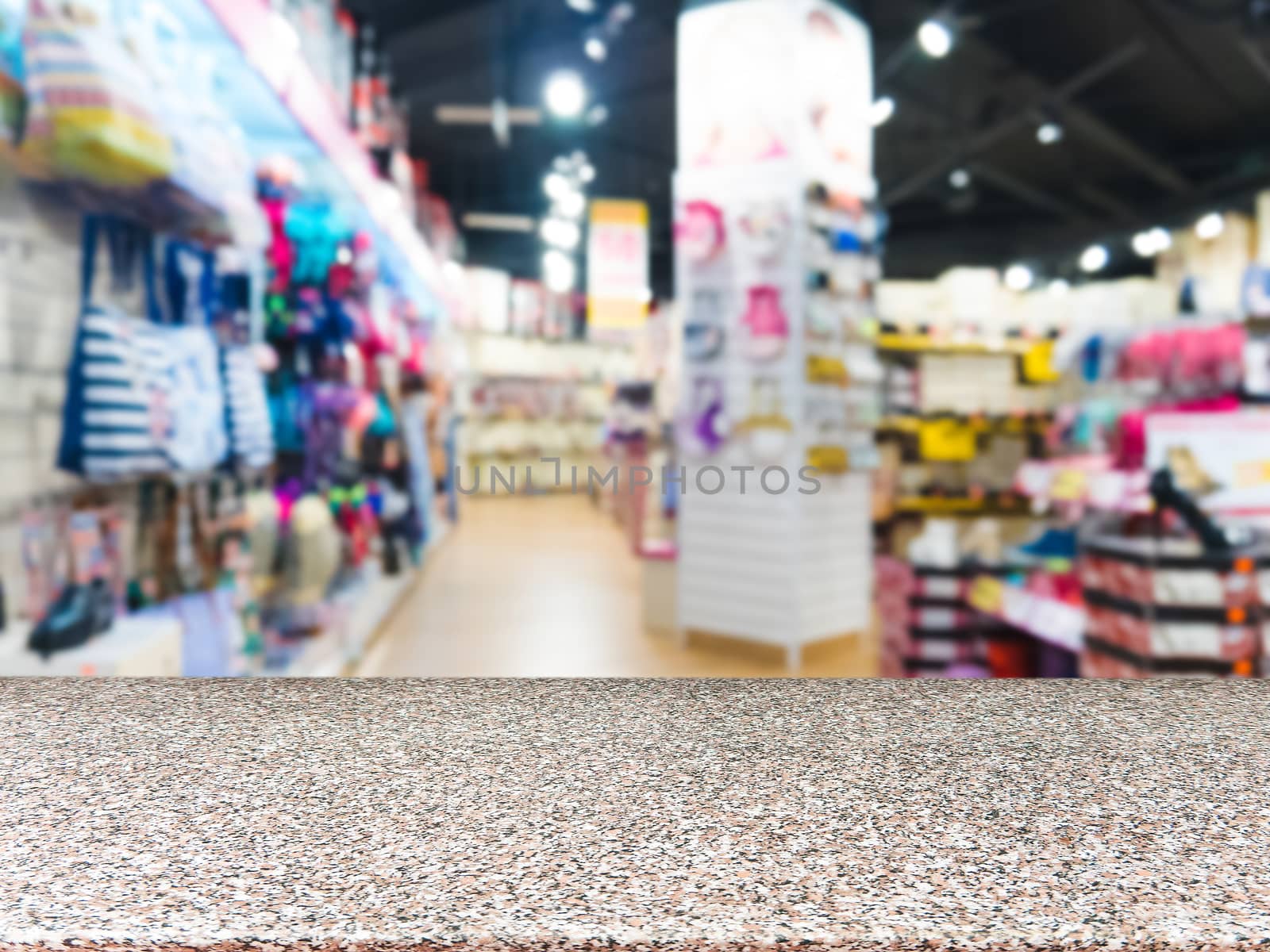 Marble board empty table in front of blurred supermarket - can be used for display or montage your products. Mockup for display of product.