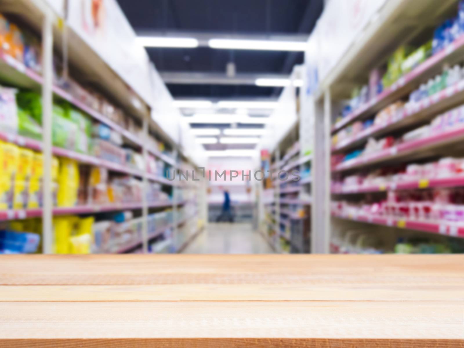 Light wooden board empty table in front of blurred background. Perspective light wood over blur in supermarket - can be used for display or montage your products. Mockup for display of product.
