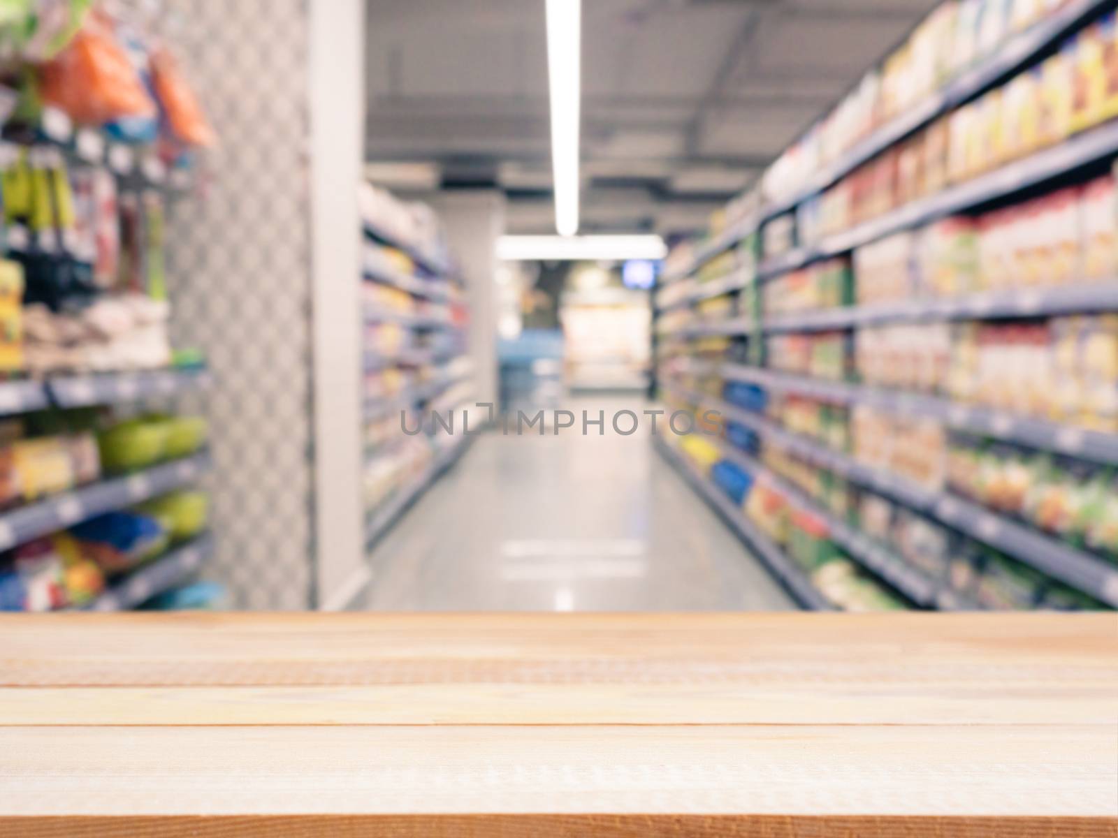 Light wooden board empty table in front of blurred background. Perspective light wood over blur in supermarket - can be used for display or montage your products. Mockup for display of product.