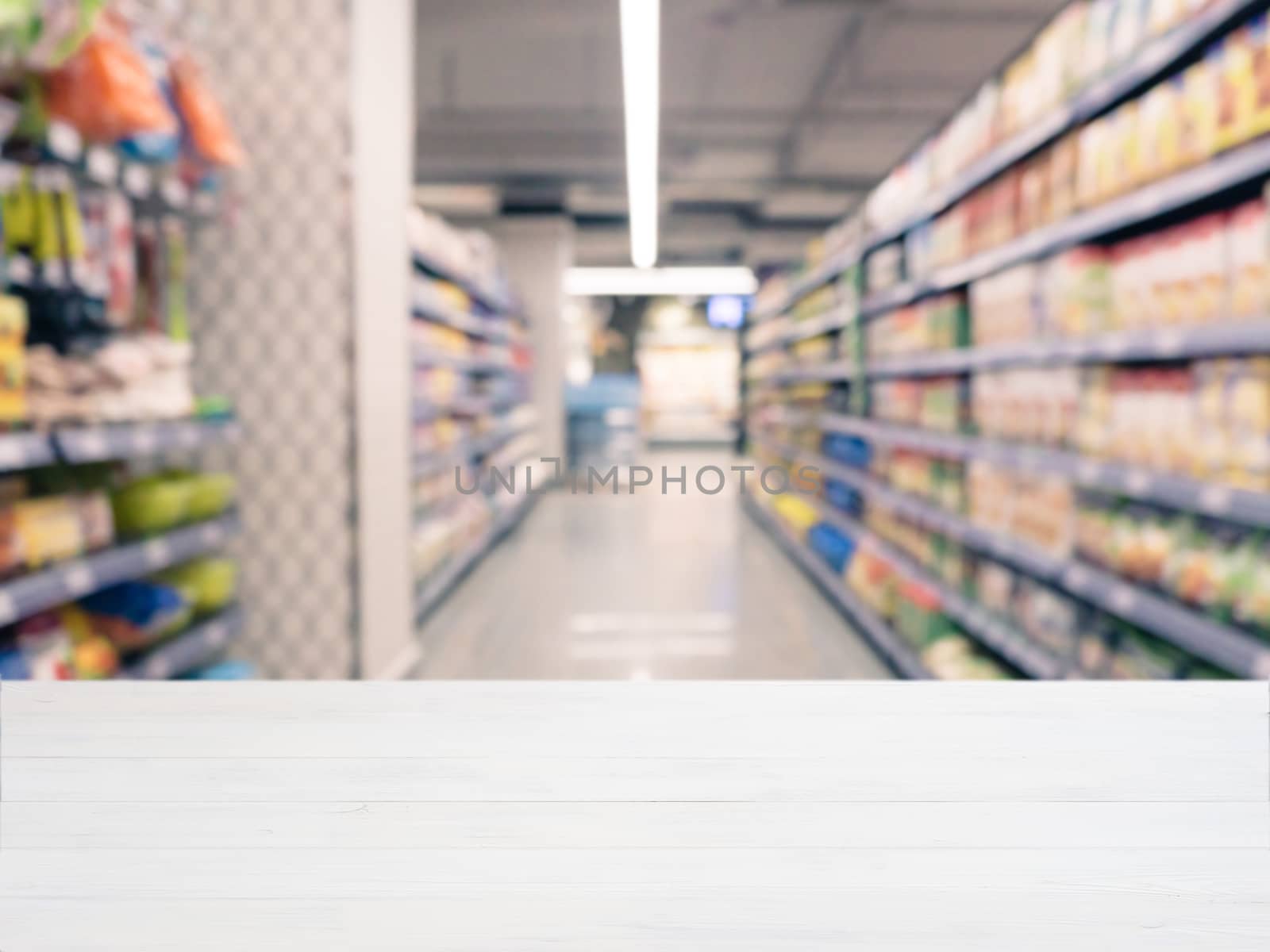 White wooden board empty table in front of blurred background. Perspective white wood over blur in supermarket - can be used for display or montage your products. Mockup for display of product.