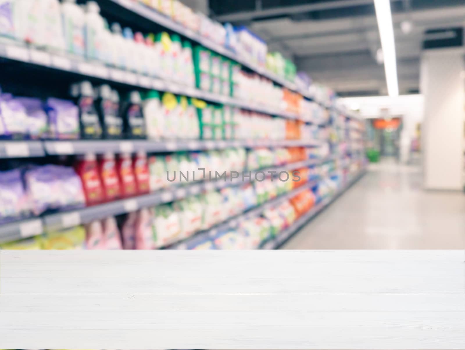 White wooden board empty table in front of blurred background. Perspective white wood over blur in supermarket - can be used for display or montage your products. Mockup for display of product.