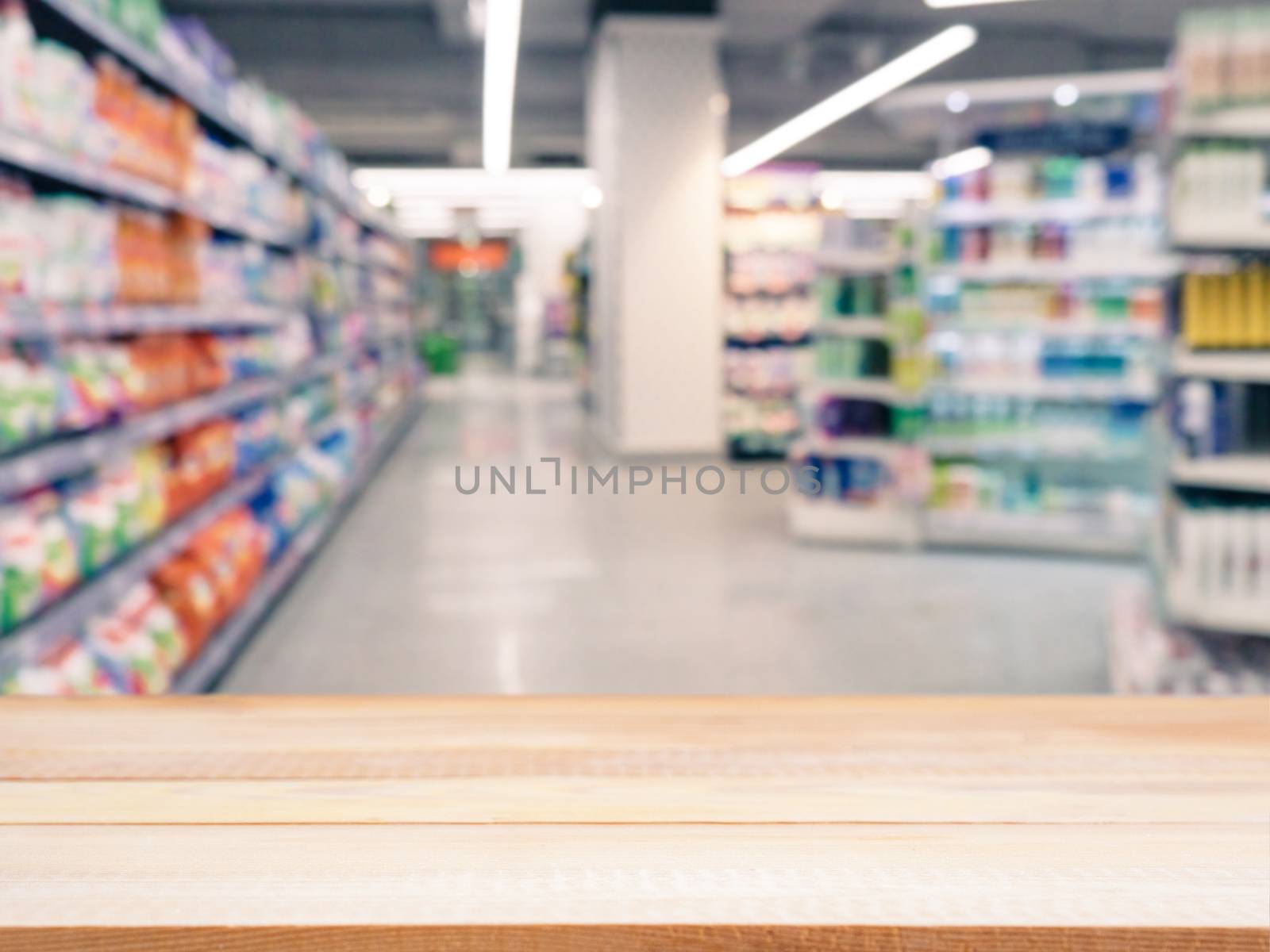 Light wooden board empty table in front of blurred background. Perspective light wood over blur in supermarket - can be used for display or montage your products. Mockup for display of product.