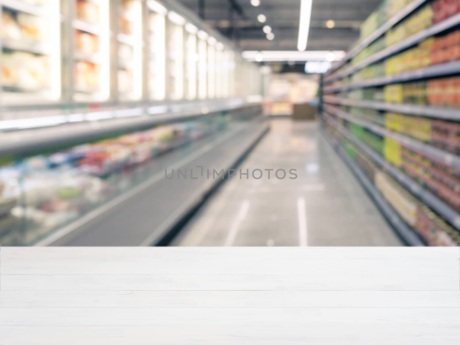 White wooden board empty table in front of blurred background. Perspective white wood over blur in supermarket - can be used for display or montage your products. Mockup for display of product.