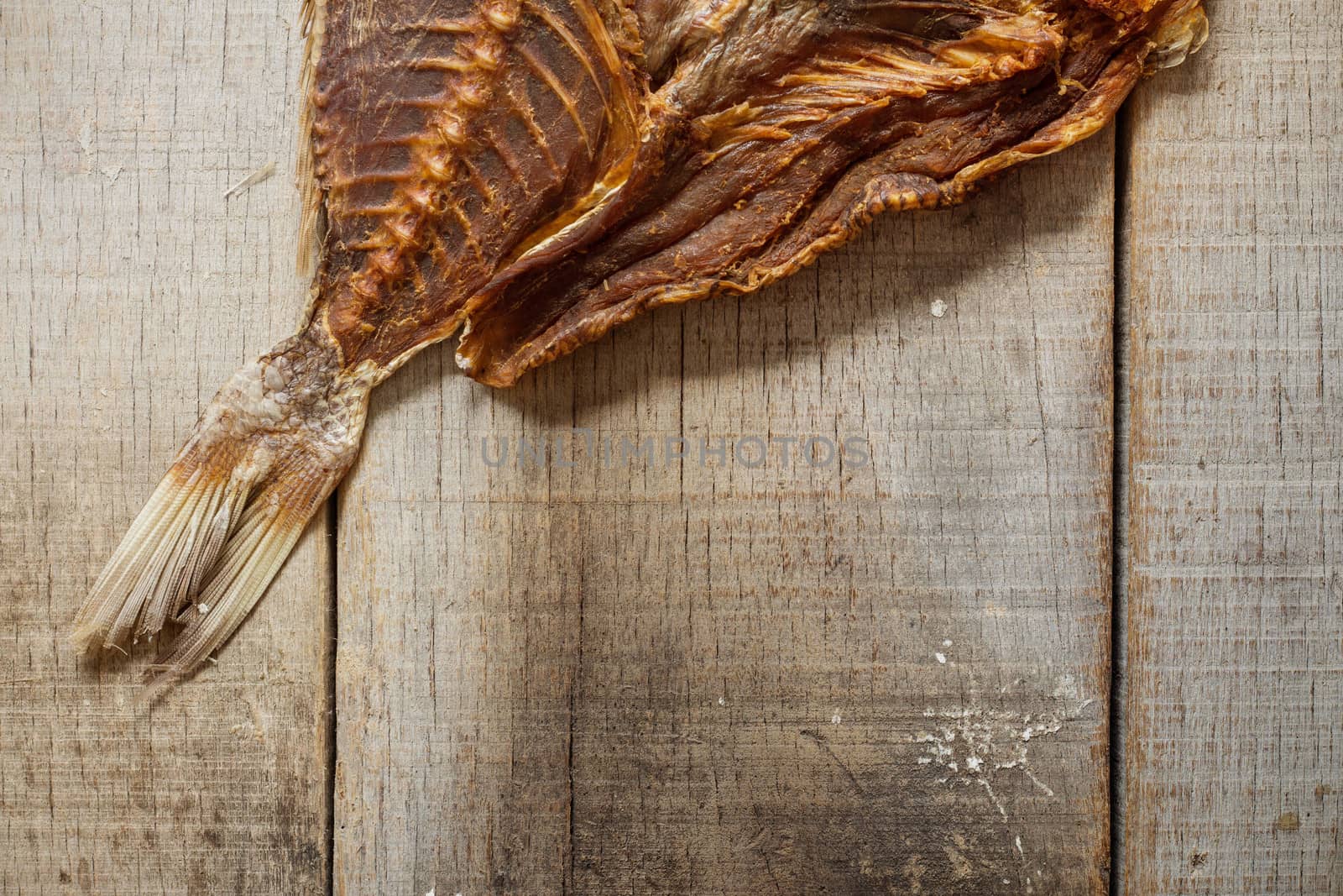 Dried fish on the old wooden floor.