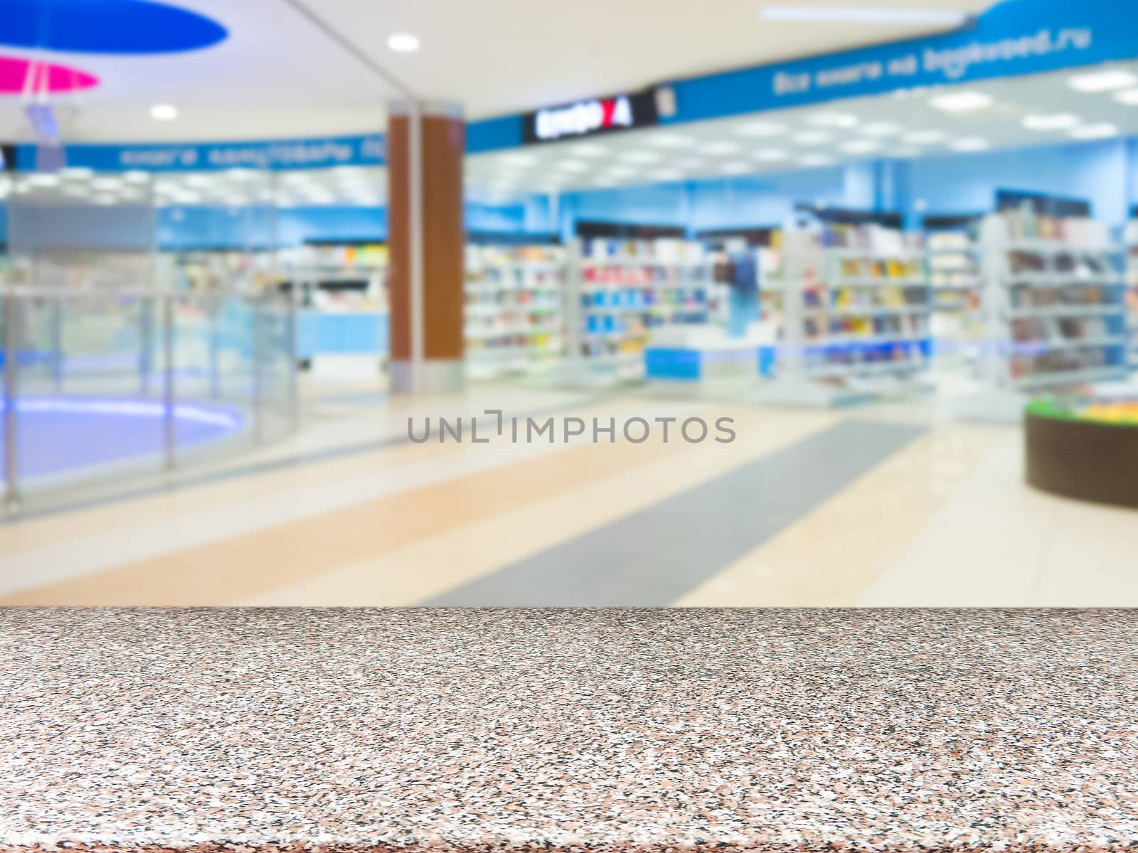 Marble board empty table in front of blurred shopping mall - can be used for display or montage your products. Mockup for display of product.