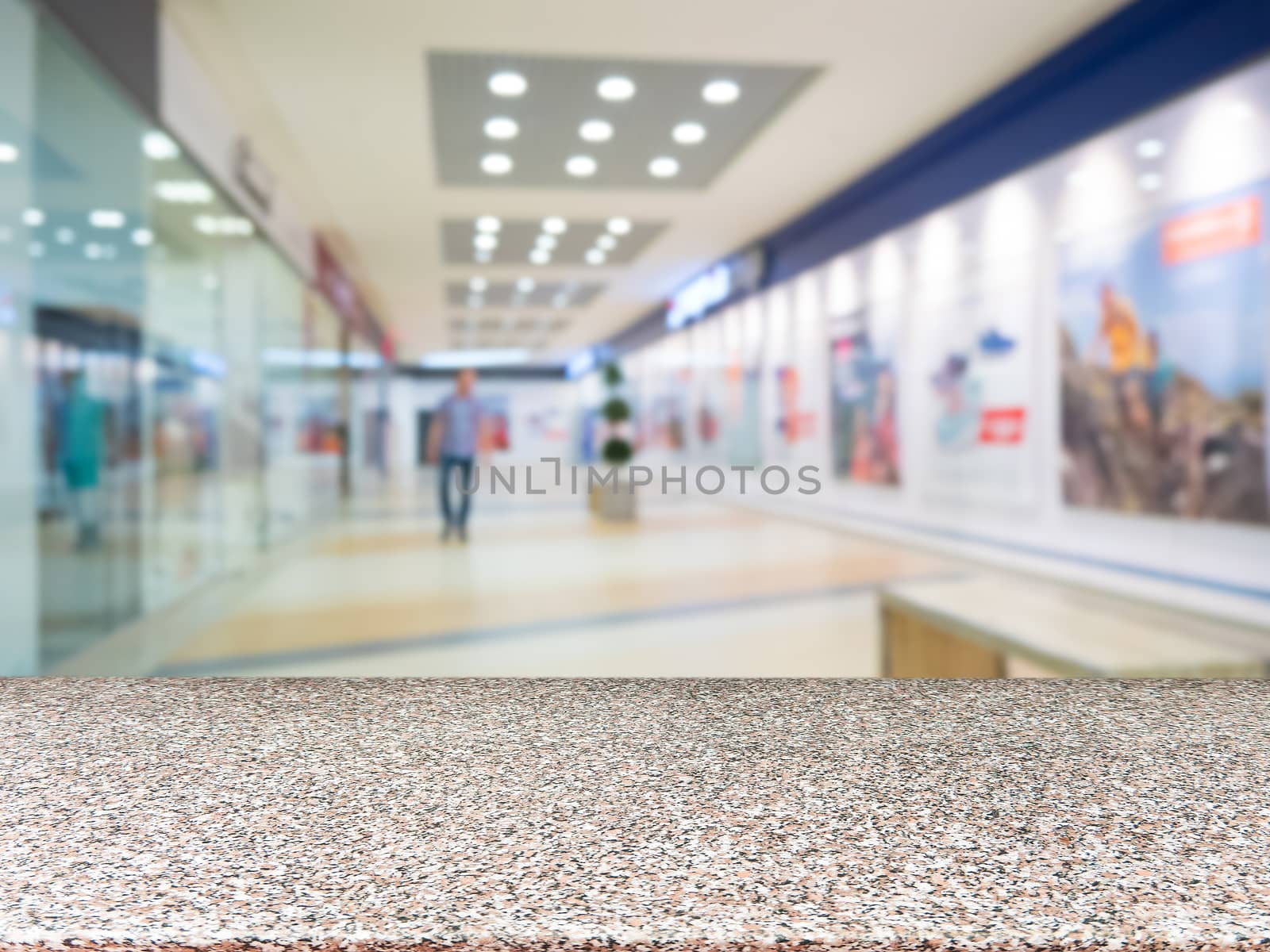 Marble board empty table in front of blurred shopping mall - can be used for display or montage your products. Mockup for display of product.