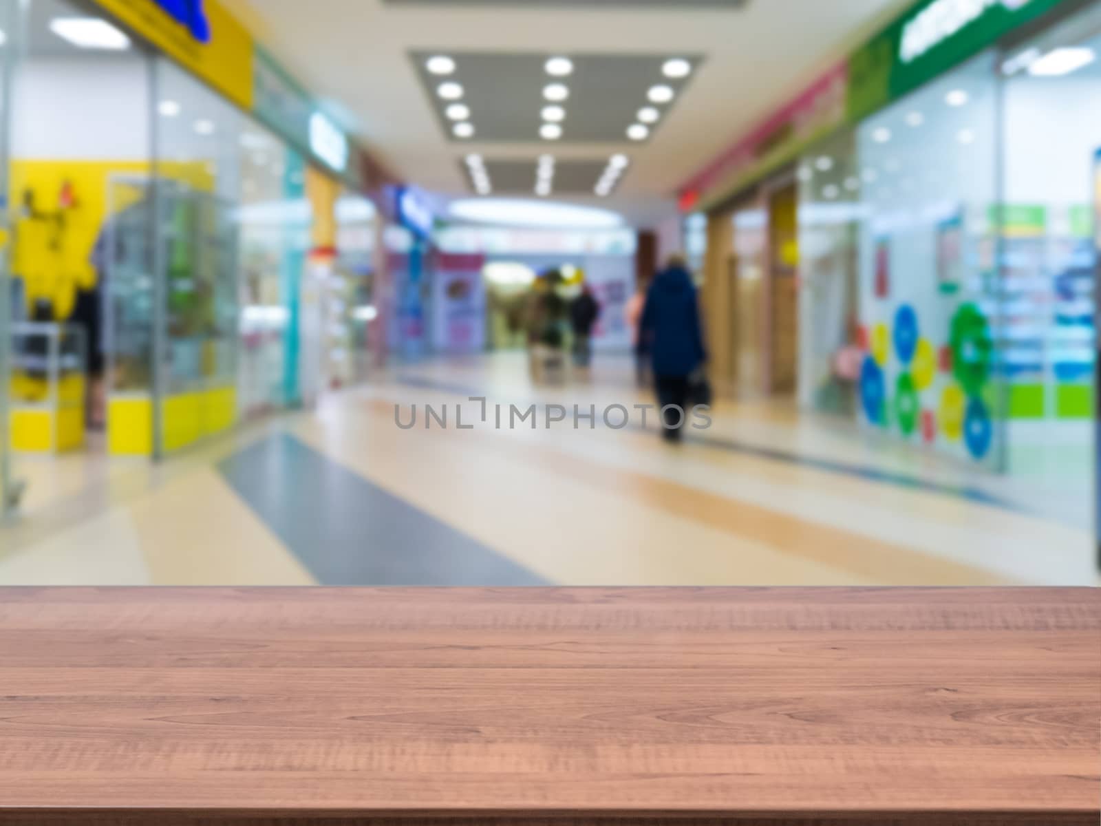 Brown wooden board empty table in front of blurred shopping mall - can be used for display or montage your products. Mockup for display of product.