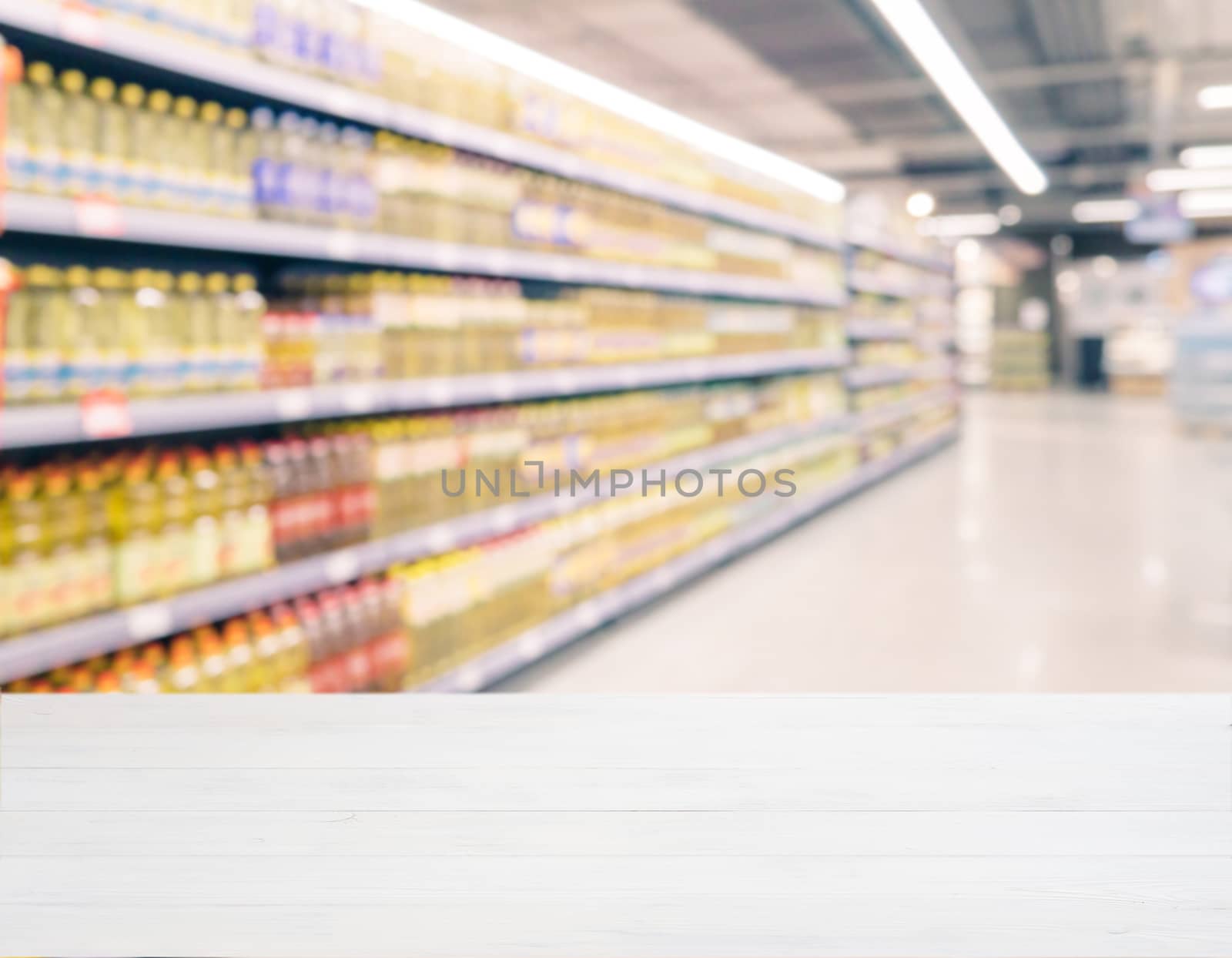 White wooden board empty table in front of blurred background. Perspective white wood over blur in supermarket - can be used for display or montage your products. Mockup for display of product.