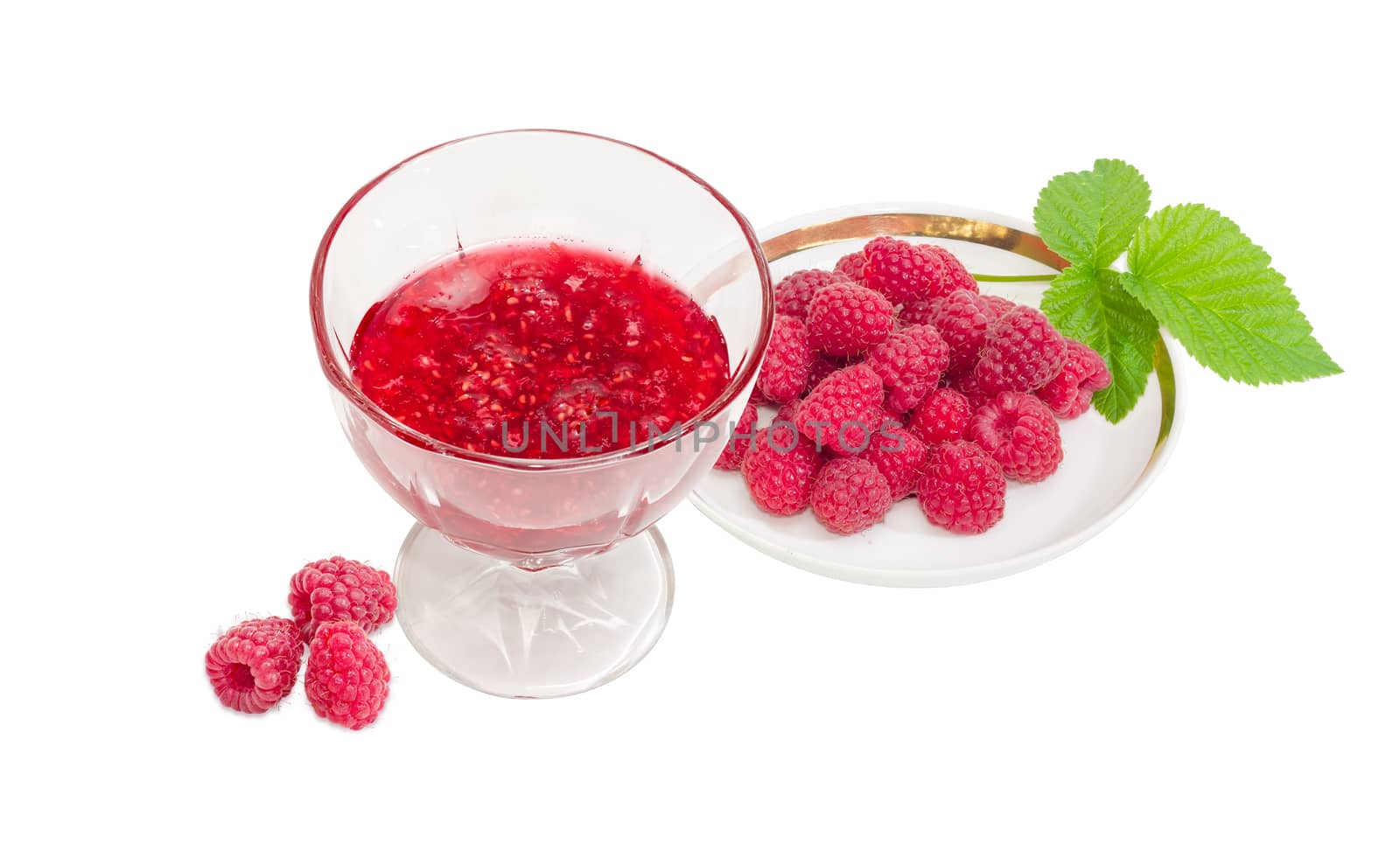 Raspberry jam in the glass dessert stem bowl and fresh cultivated red raspberries on saucer with leaf and several berries separately beside on a light background
