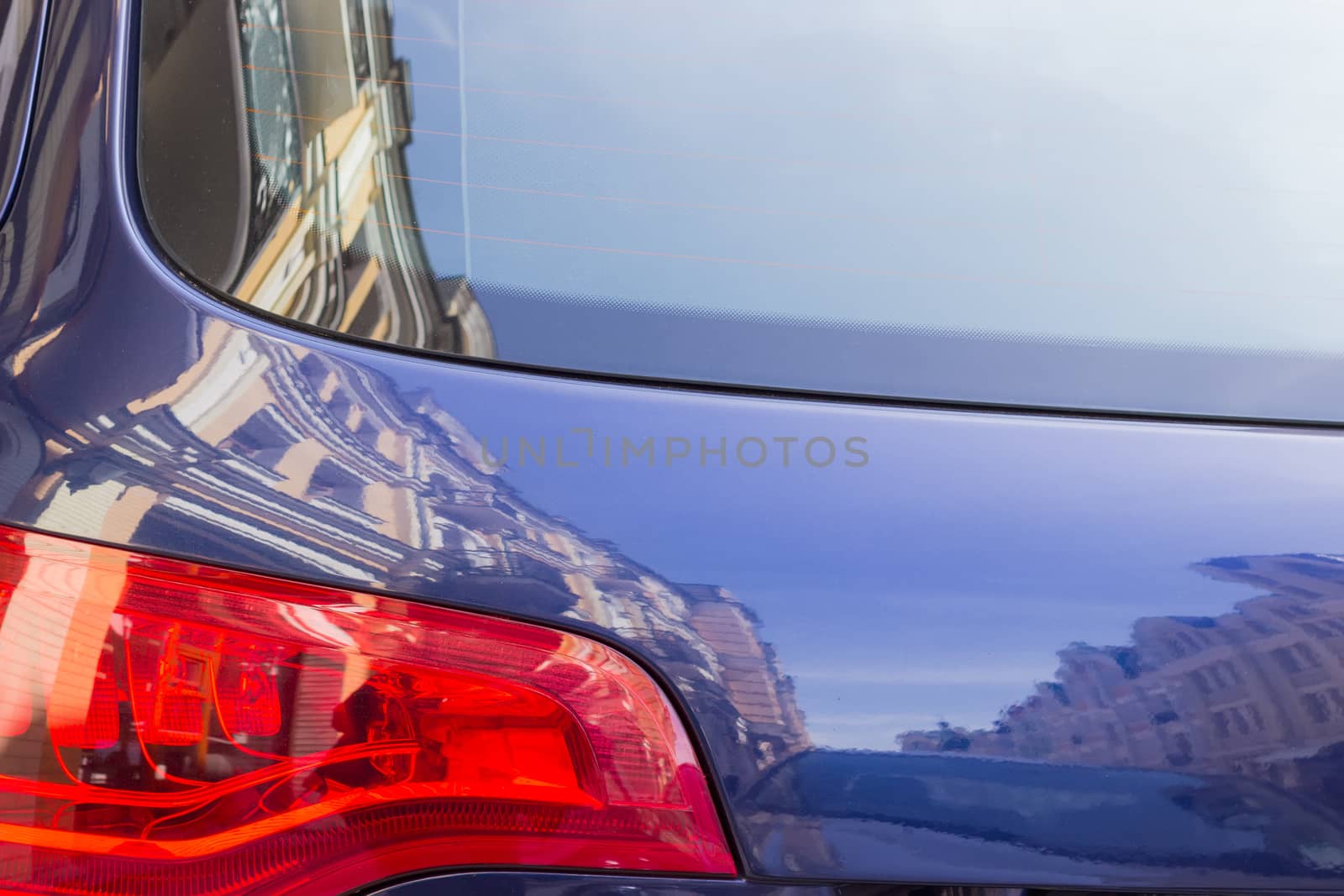 Fragment of back of the car with houses reflection by anmbph