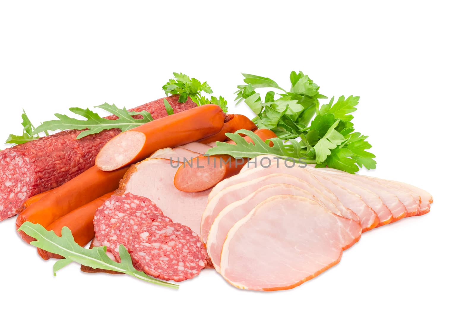 Sliced boiled smoked pork loin and ham, partly sliced salami and hunting sausages with arugula and parsley closeup on a light background
