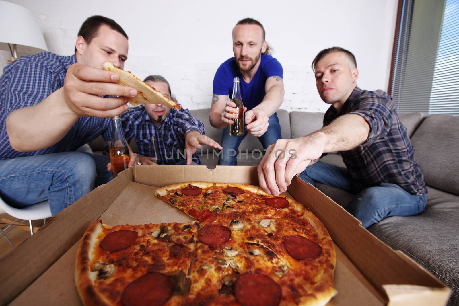 Friends taking pizza by destillat