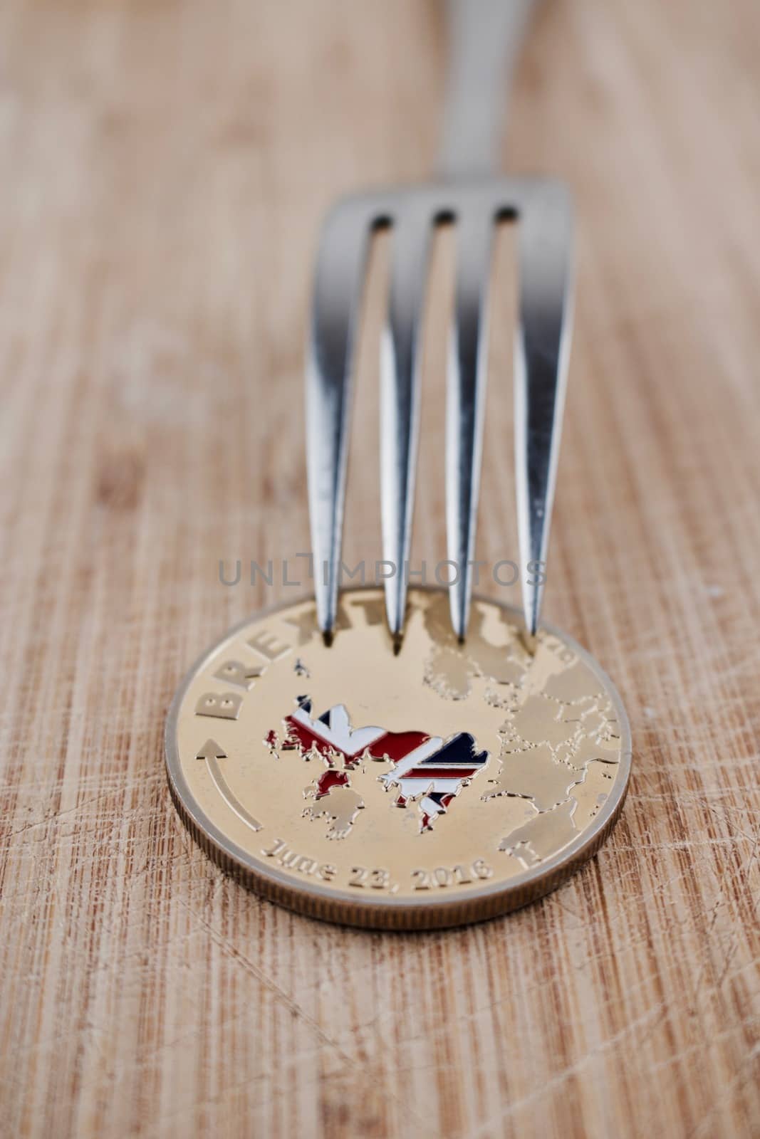 Physical brexit coin on the wooden board. Europe leaving concept.
