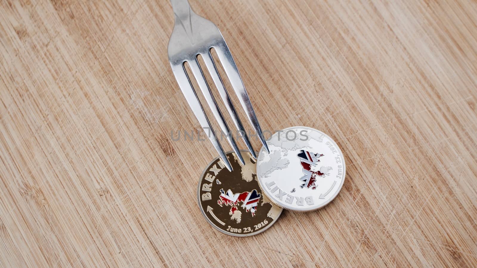 Physical brexit coin on the wooden board. Europe leaving concept.