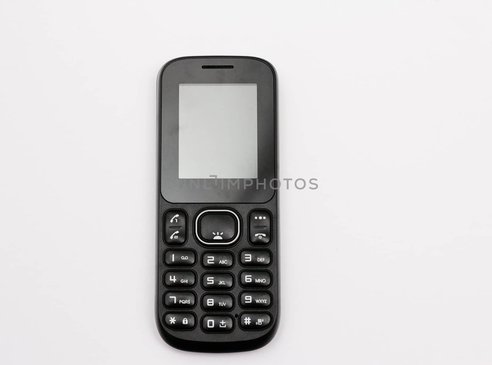 Push-button mobile phone in black isolated on white background.