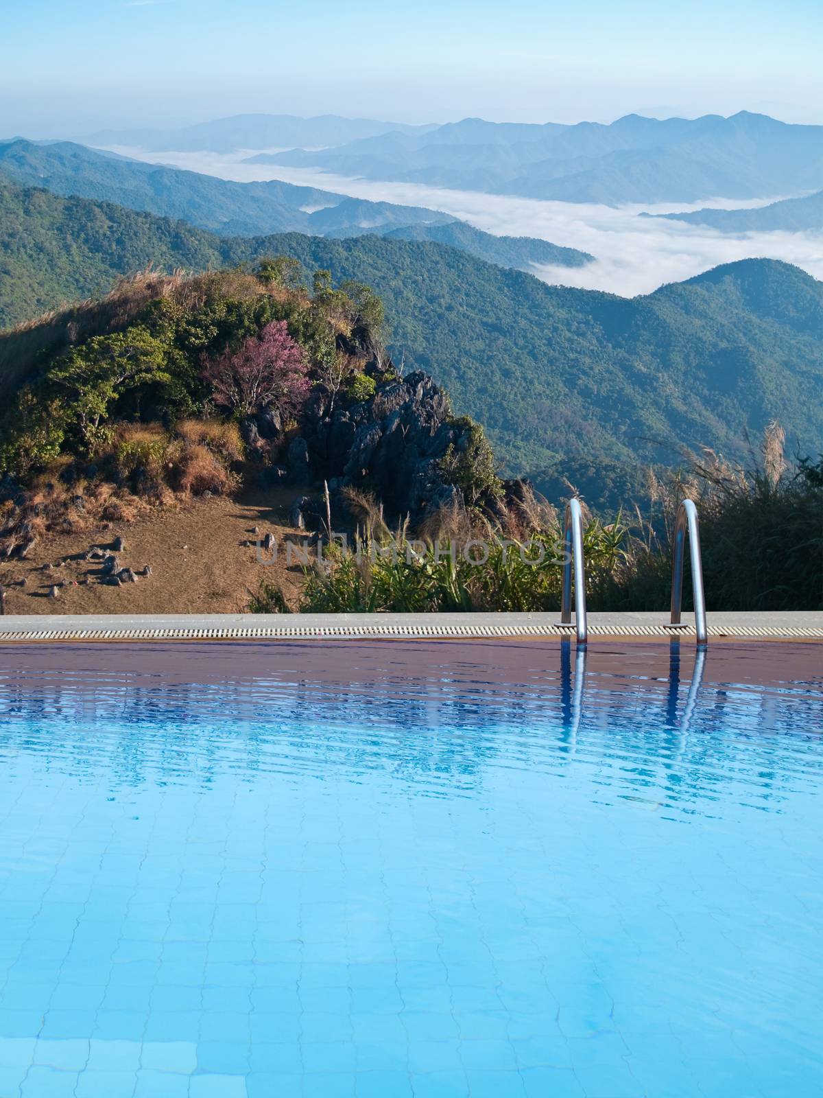 Outdoor swimming pool on top of mountain with mist