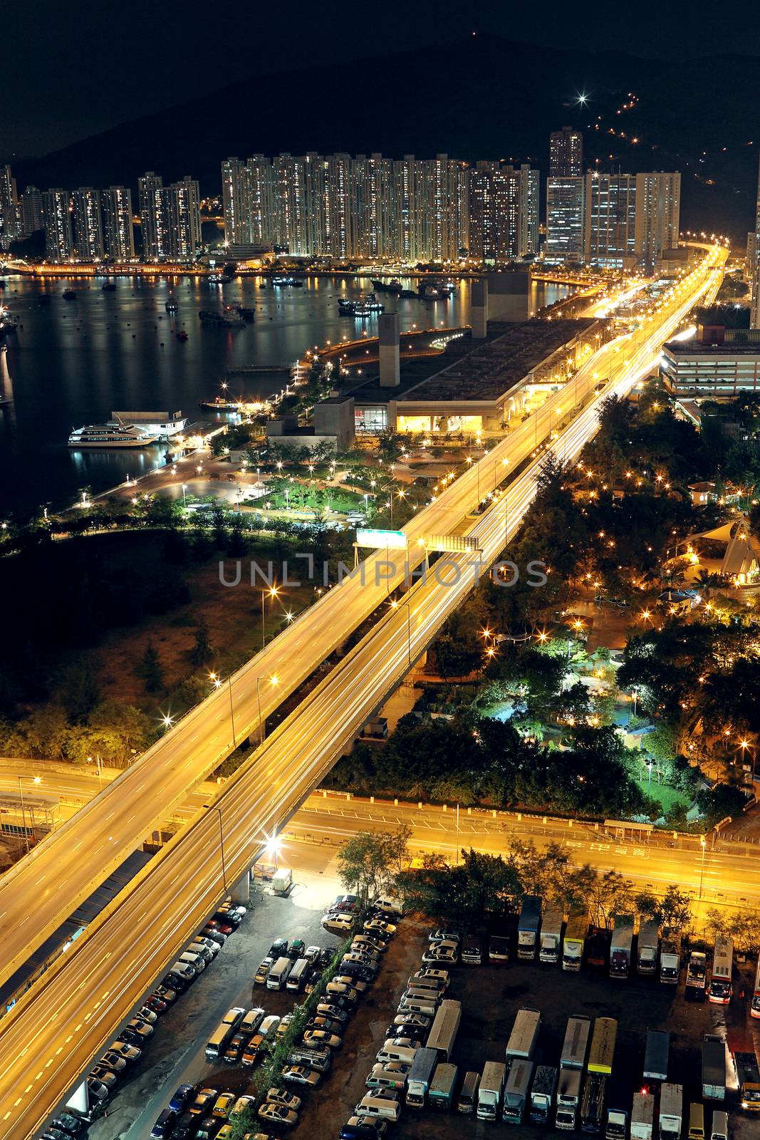 traffic in modern city at night by cozyta