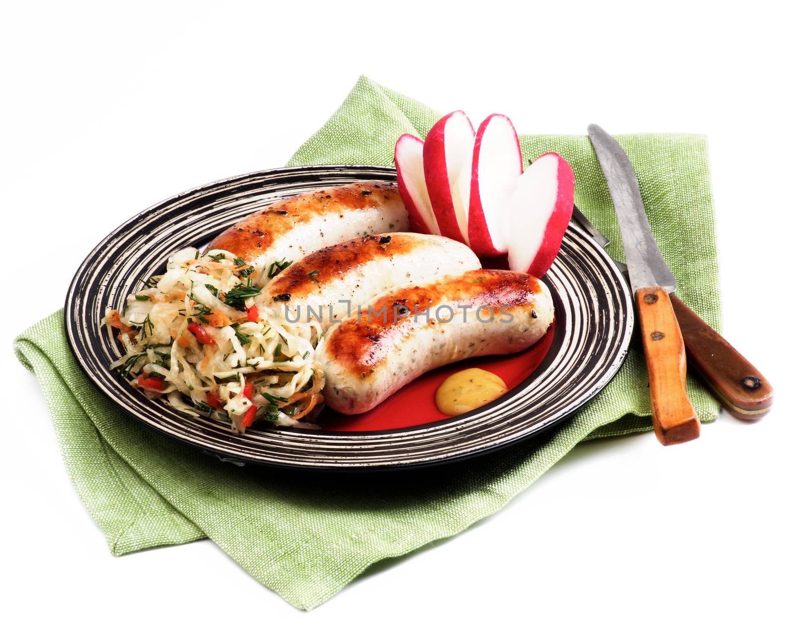 Delicious Grilled White Munich Sausages with Pickled Cabbage, Chopped Radish and Mustard Sauce on Red Striped Plate isolated on White background
