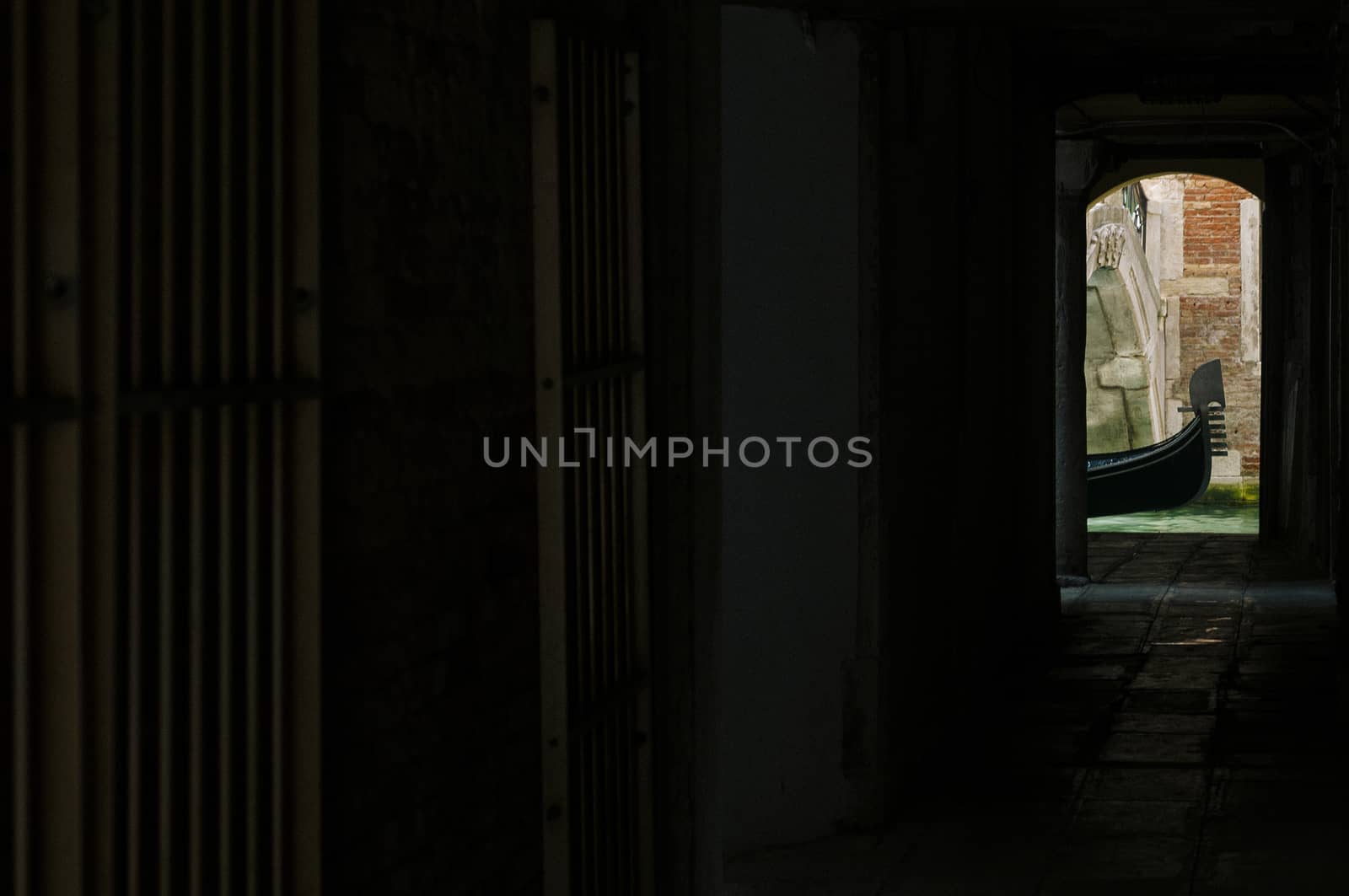 View of a typical gondola from a narrow and dark alley in Venice, Veneto, Italy, Europe